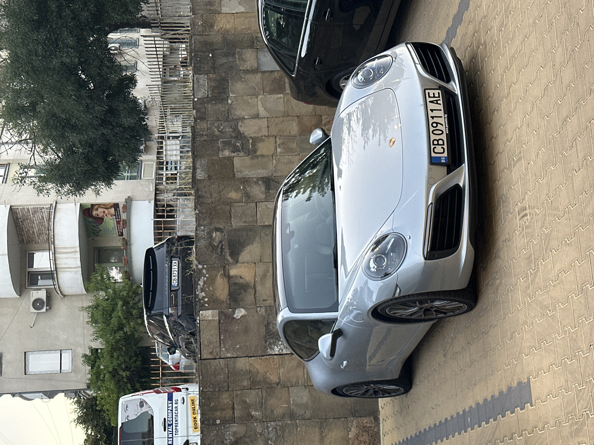 Exotic cars parked in Veliko Tarnovo on a grey afternoon