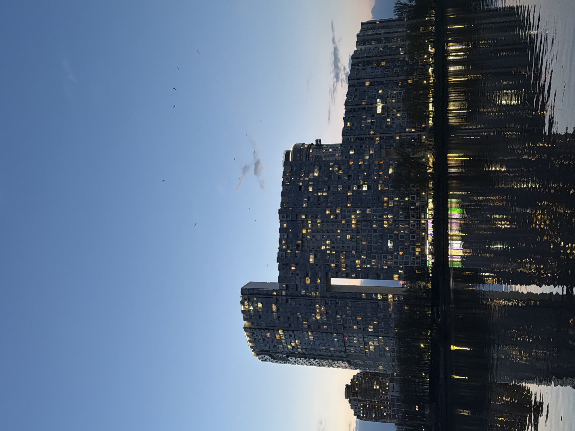 High-rise apartments reflected in water observed in Khimki