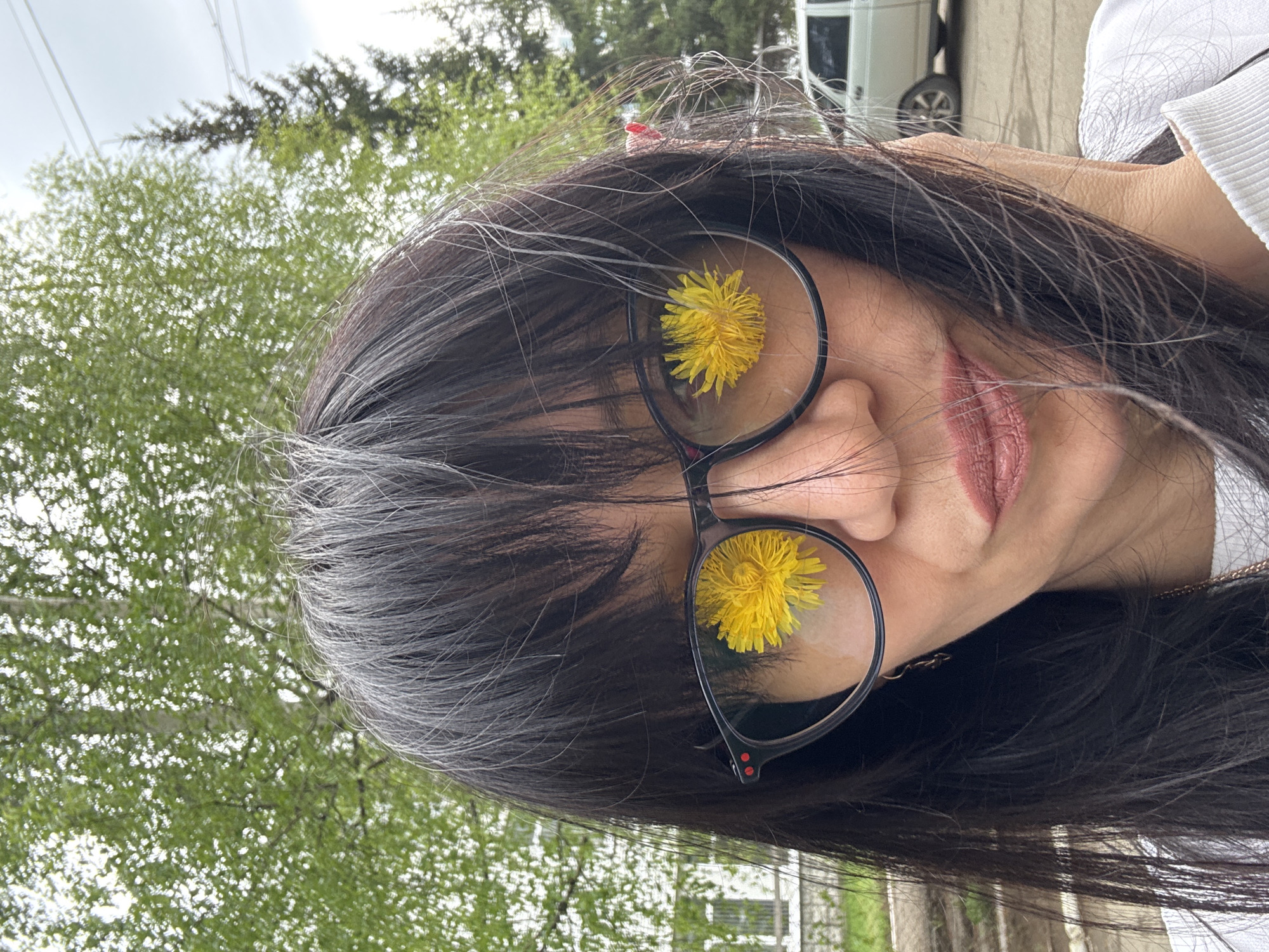Woman poses with dandelions during Chaikovsky, Russia visit
