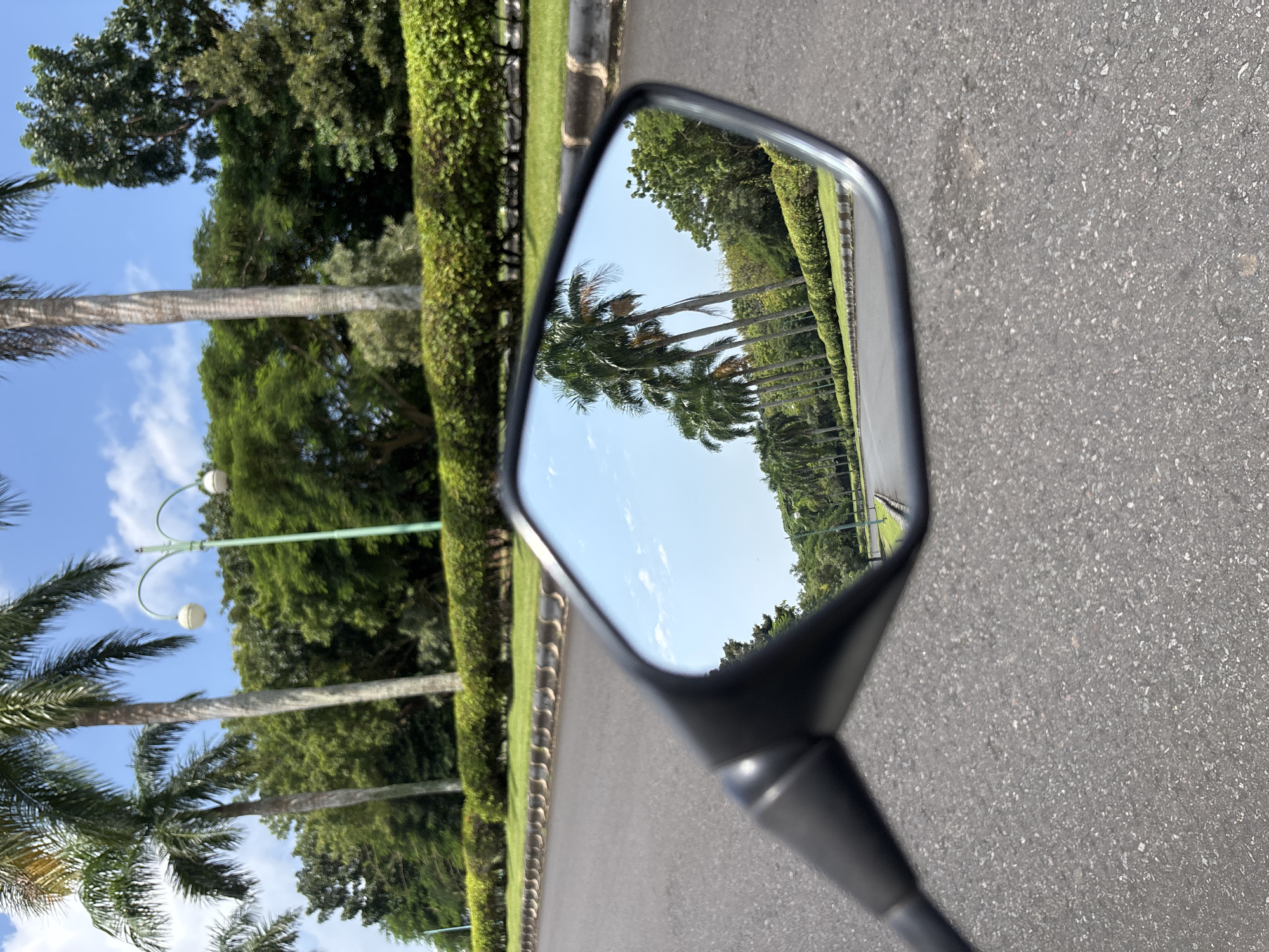 Vehicle travels daytime road in Pecatu, Indonesia