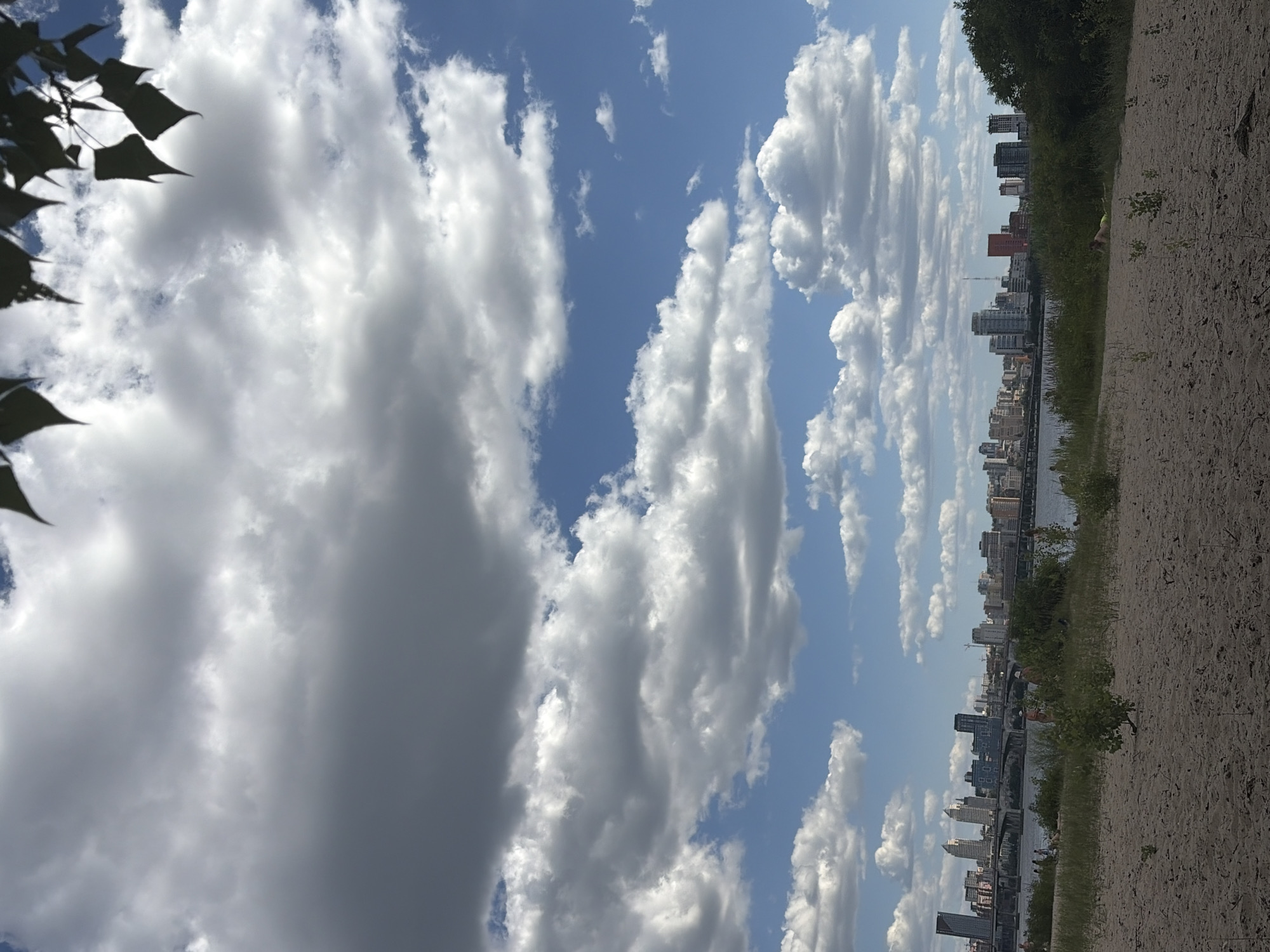 Lazy afternoon on the Dnipro riverbank, city skyline in view