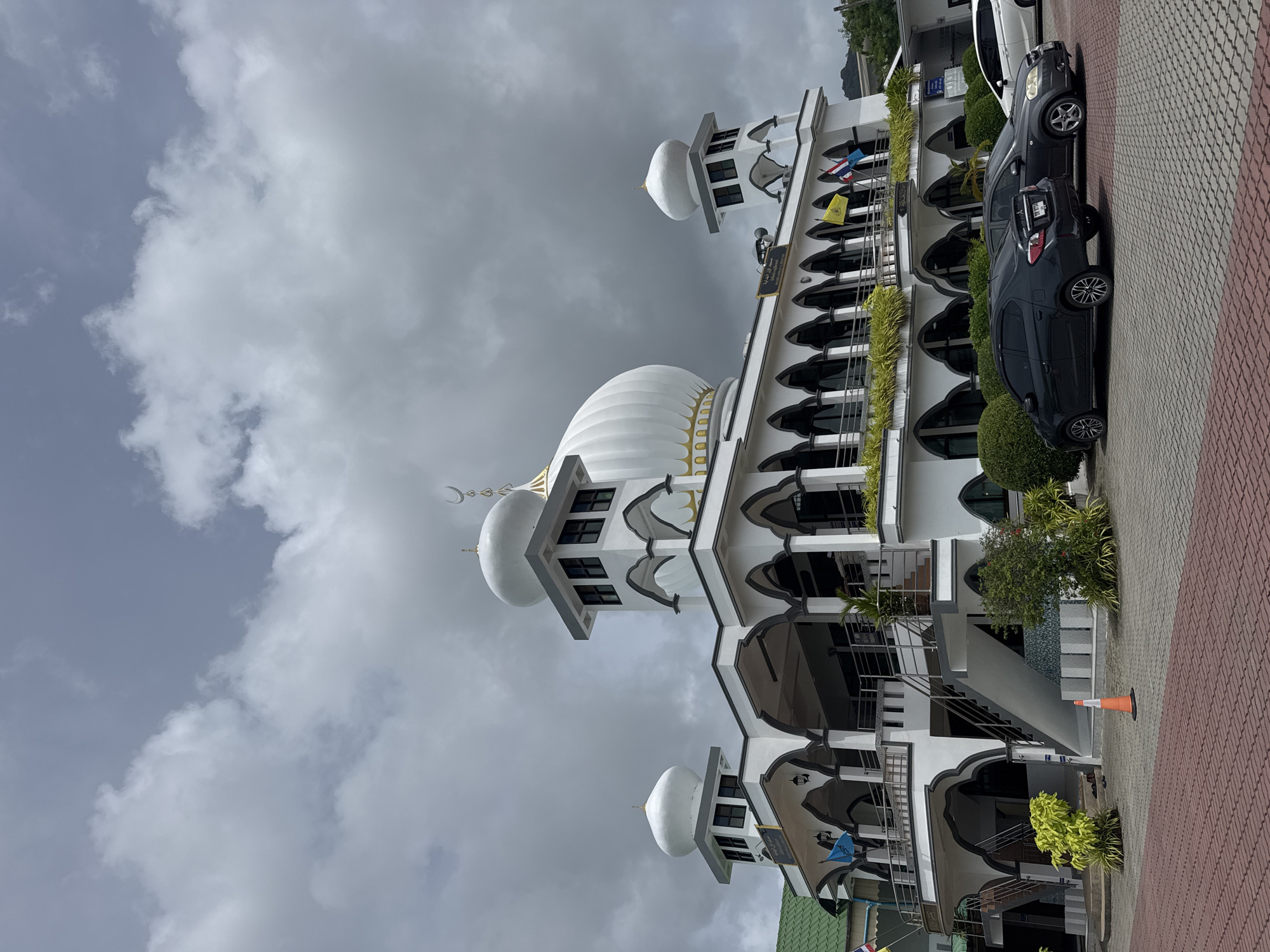 Rawai seafront on a cloudy morning — boats, mosque, coastline