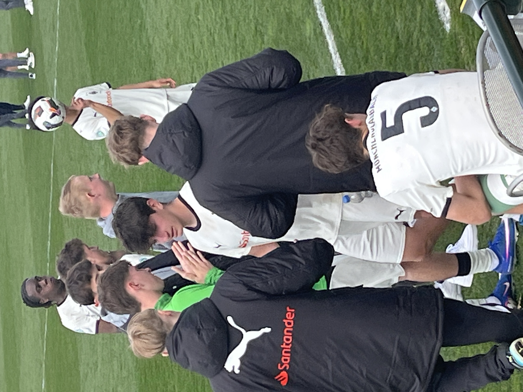 Soccer team huddles on field in Mönchengladbach training session
