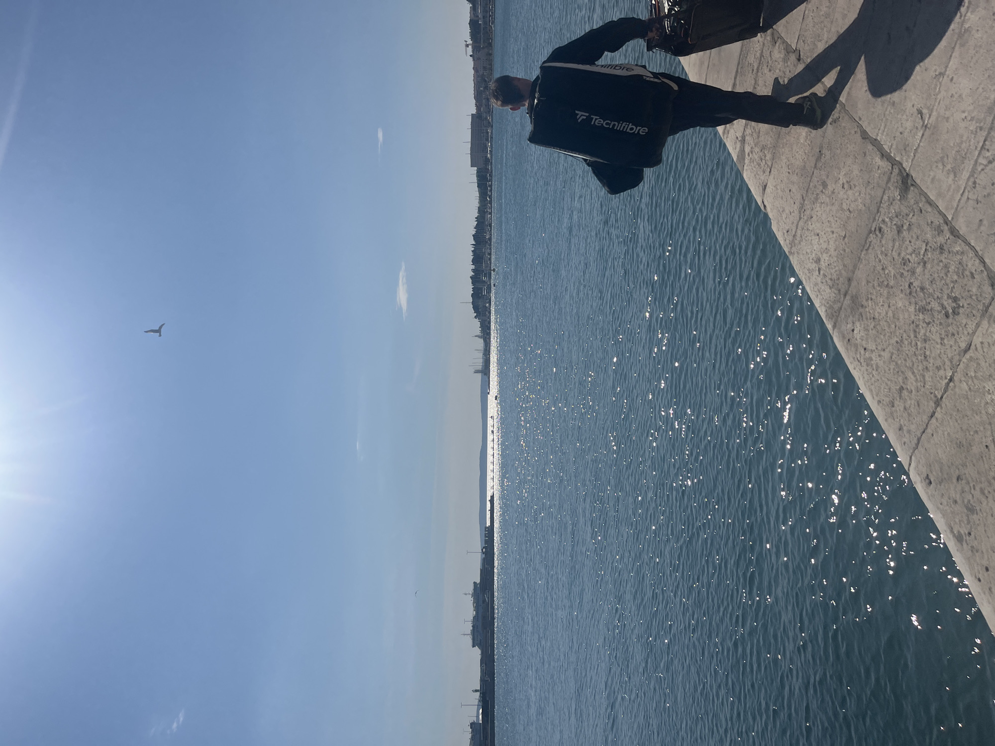 Tourist observes Adriatic Sea from Split waterfront walkway
