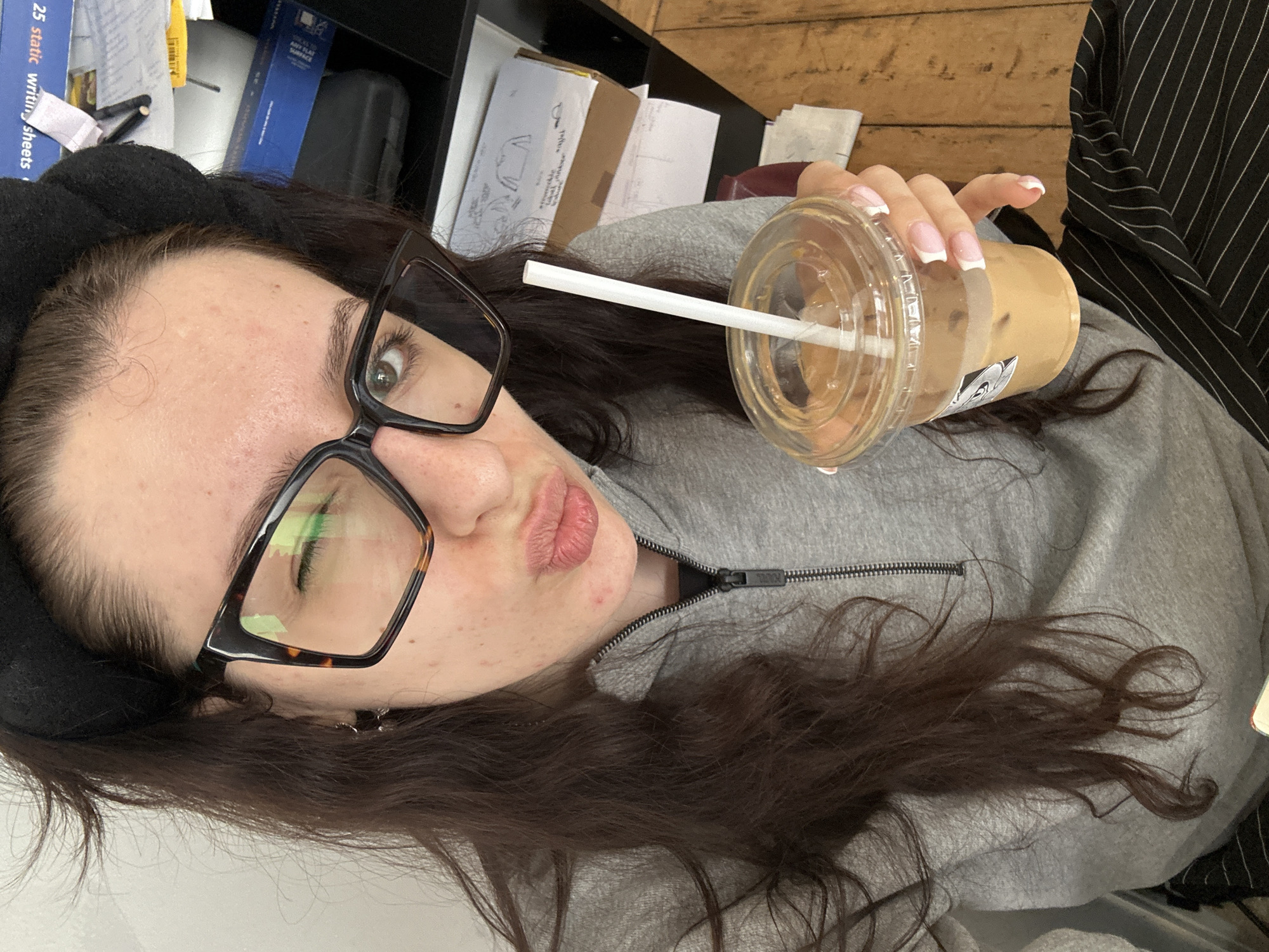 Woman documents coffee break workspace in Antwerp cafe