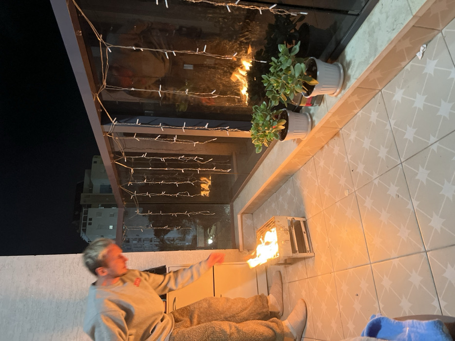 Family enjoys evening barbecue on balcony in Kiryat Bialik