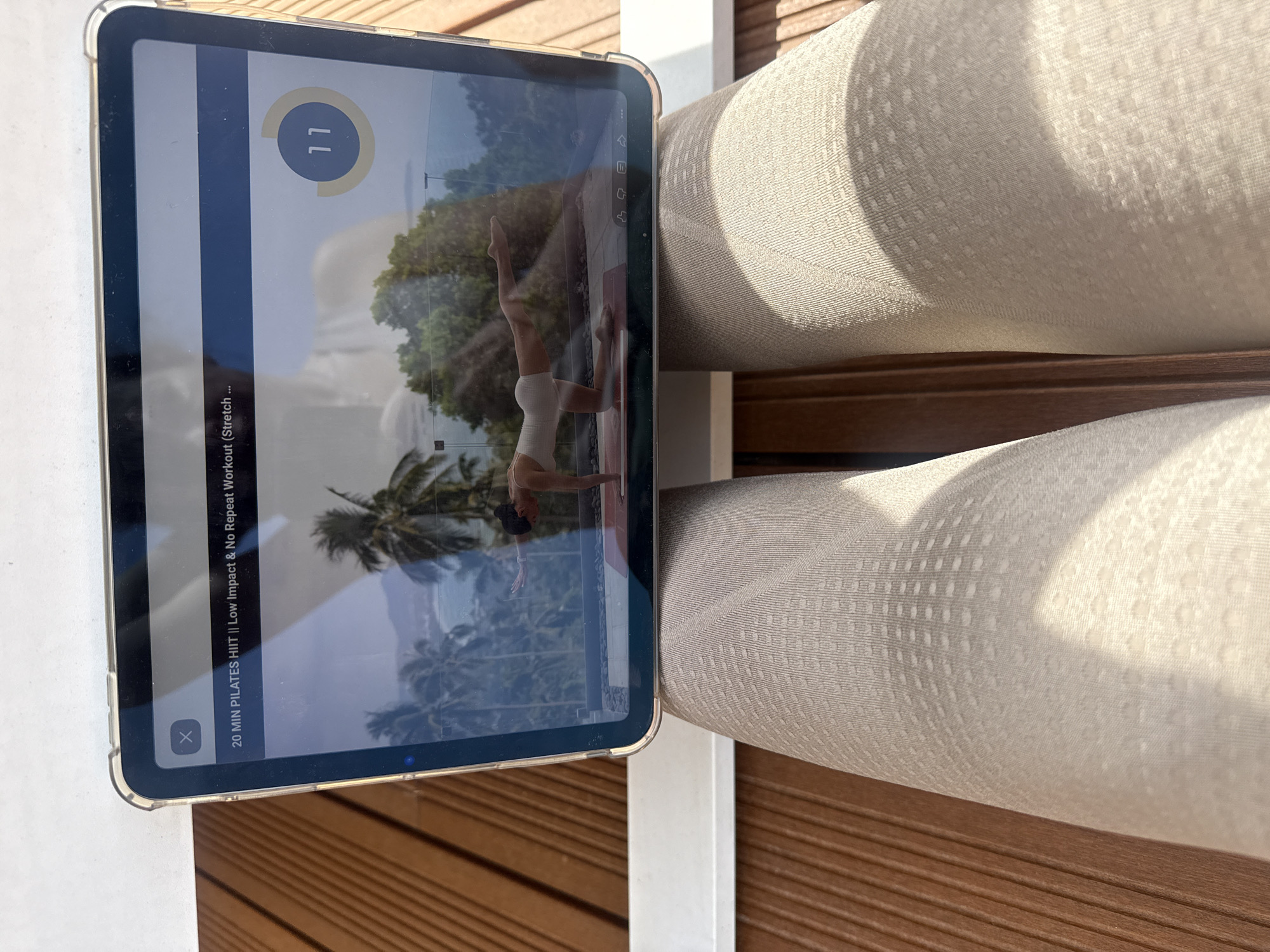 Person uses iPad on wooden deck in Vila Nova de Gaia