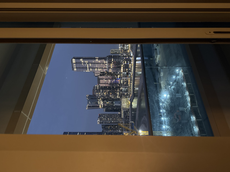 Resident watches twilight cityscape from Abu Dhabi high-rise balcony