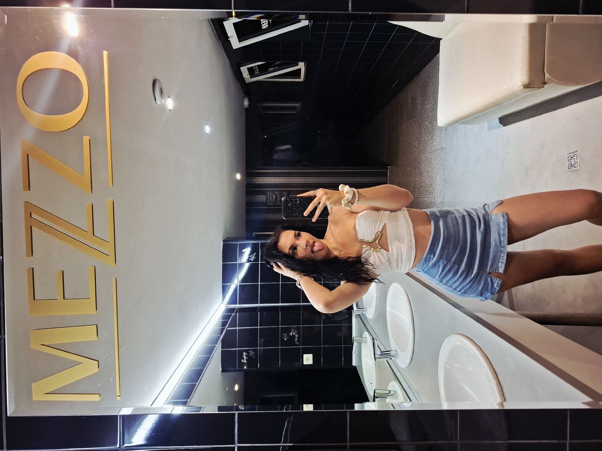 Woman takes playful mirror selfies in Mezdra bathroom