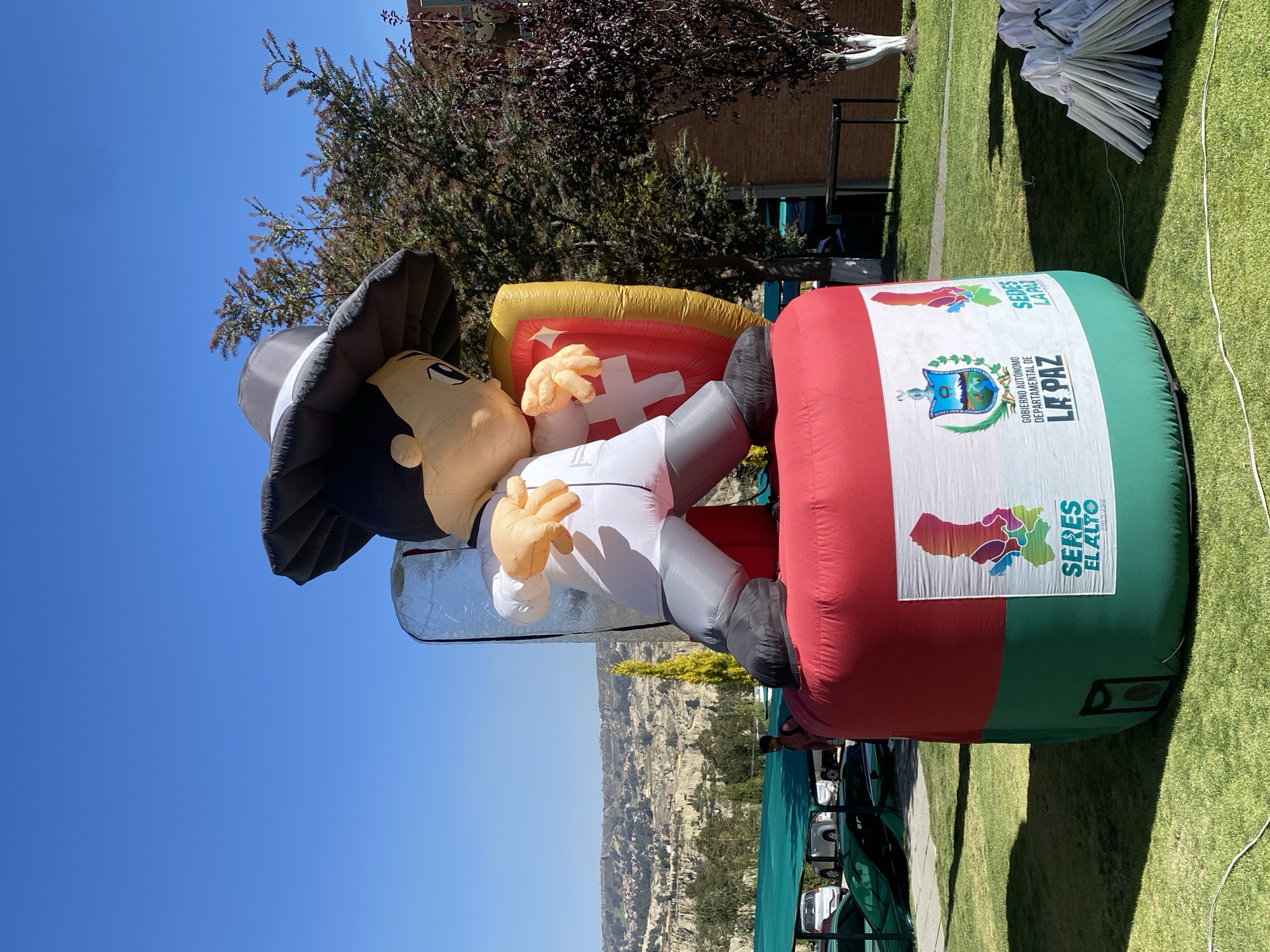 College students gather around inflatable mascot in Achocalla
