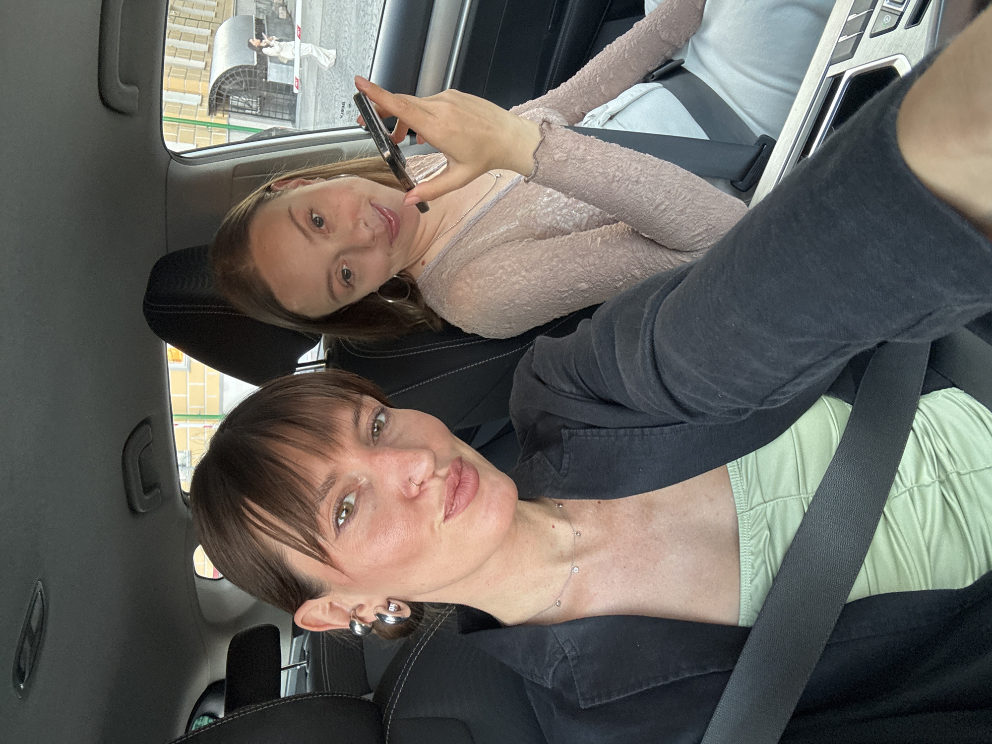 Car ride near a red brick tower on a clear day