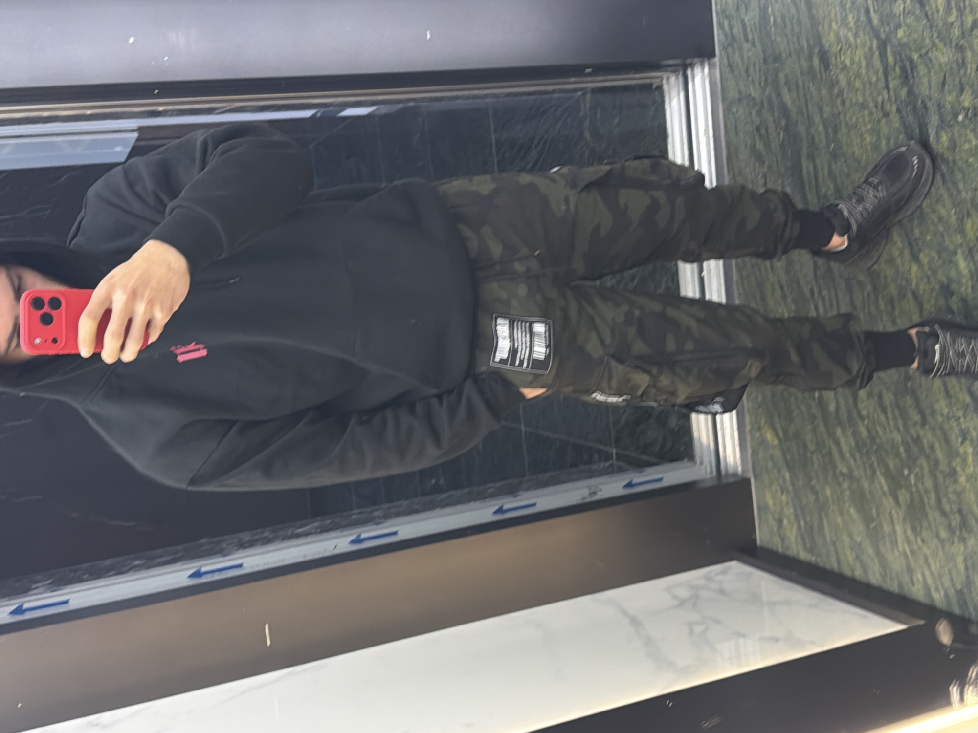 Person takes selfies with red phone in Plovdiv apartment