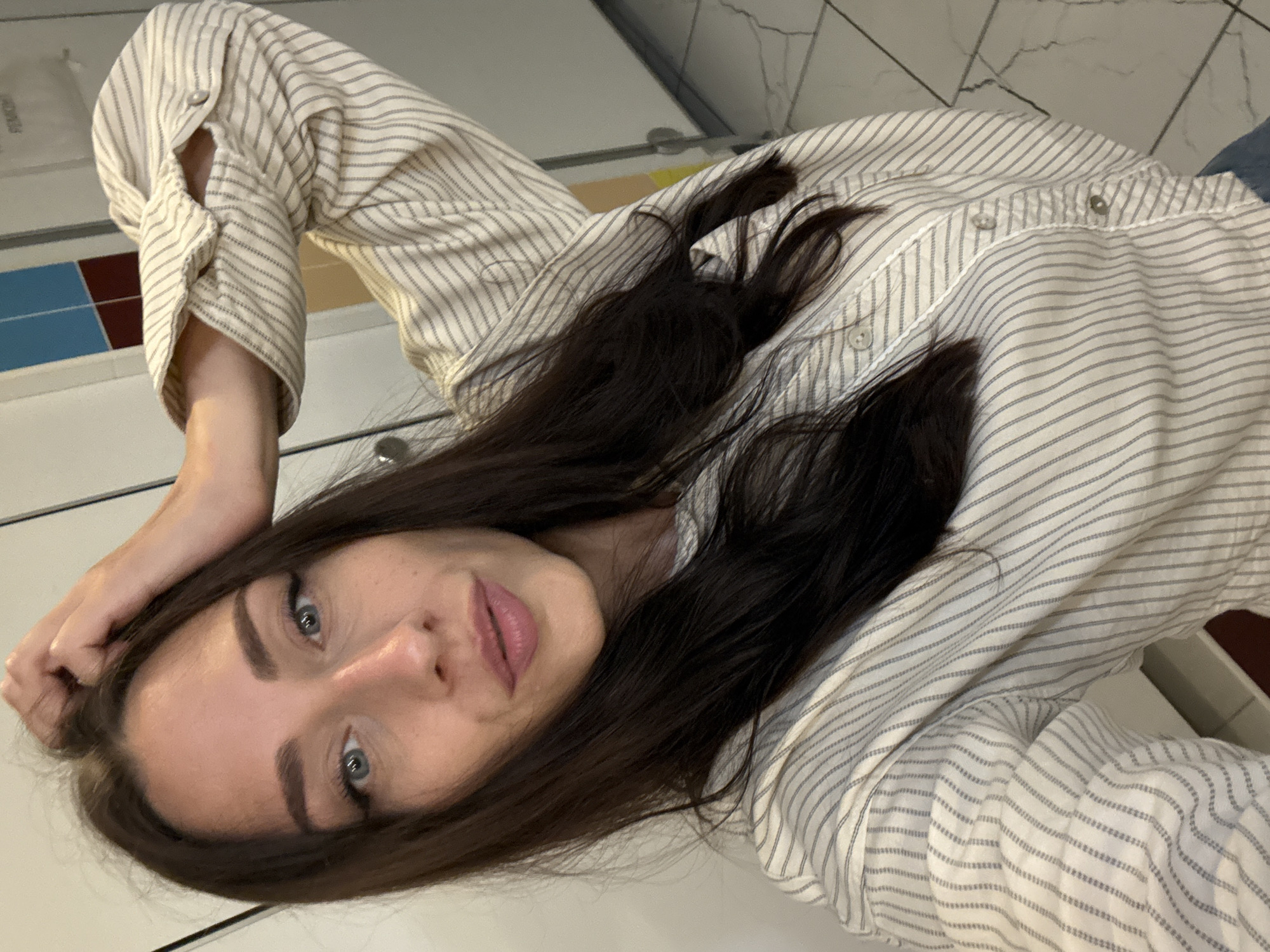 Back-to-back selfies in a locker room or restroom
