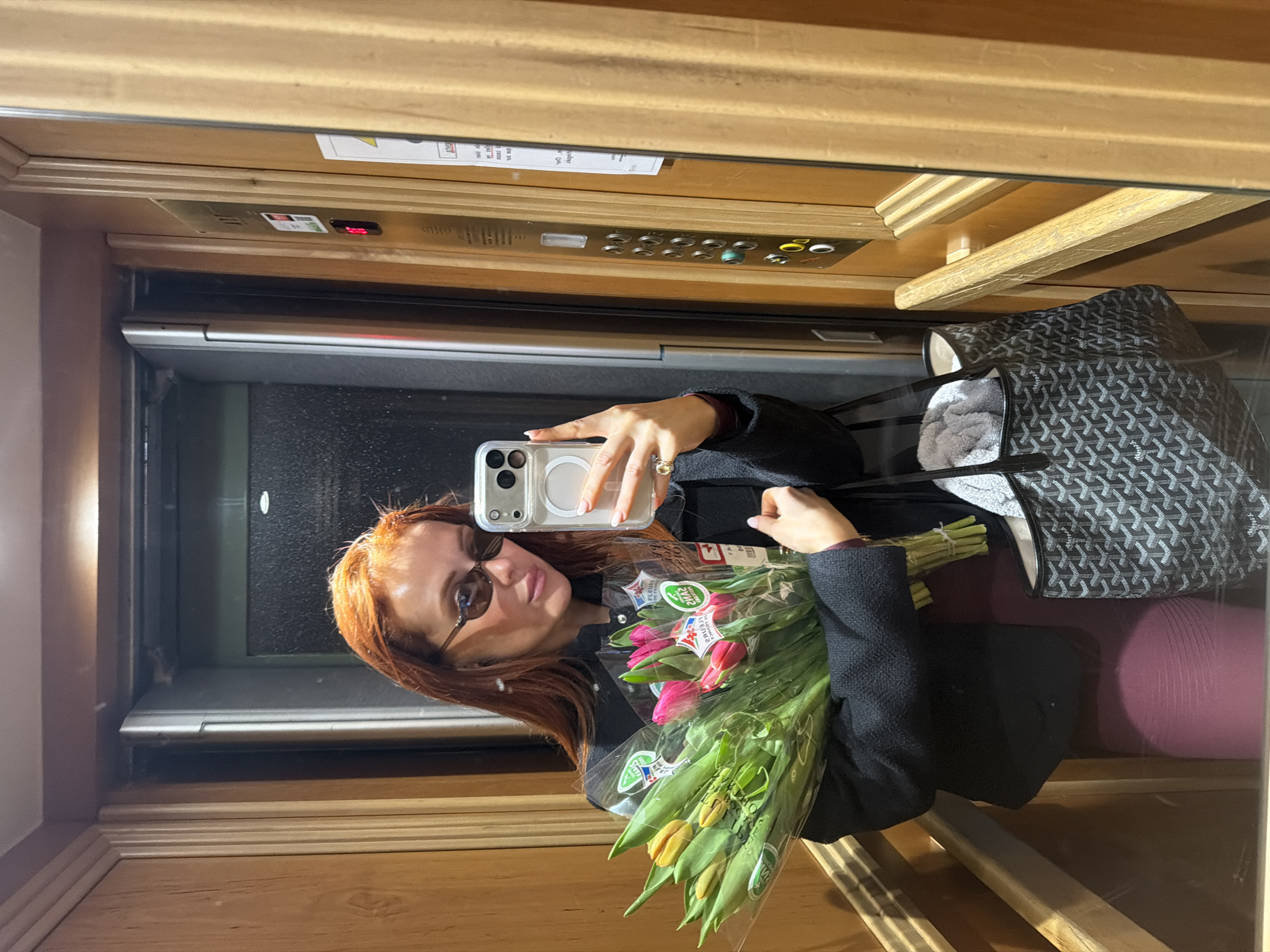 Person takes elevator selfie with tulips in Paris