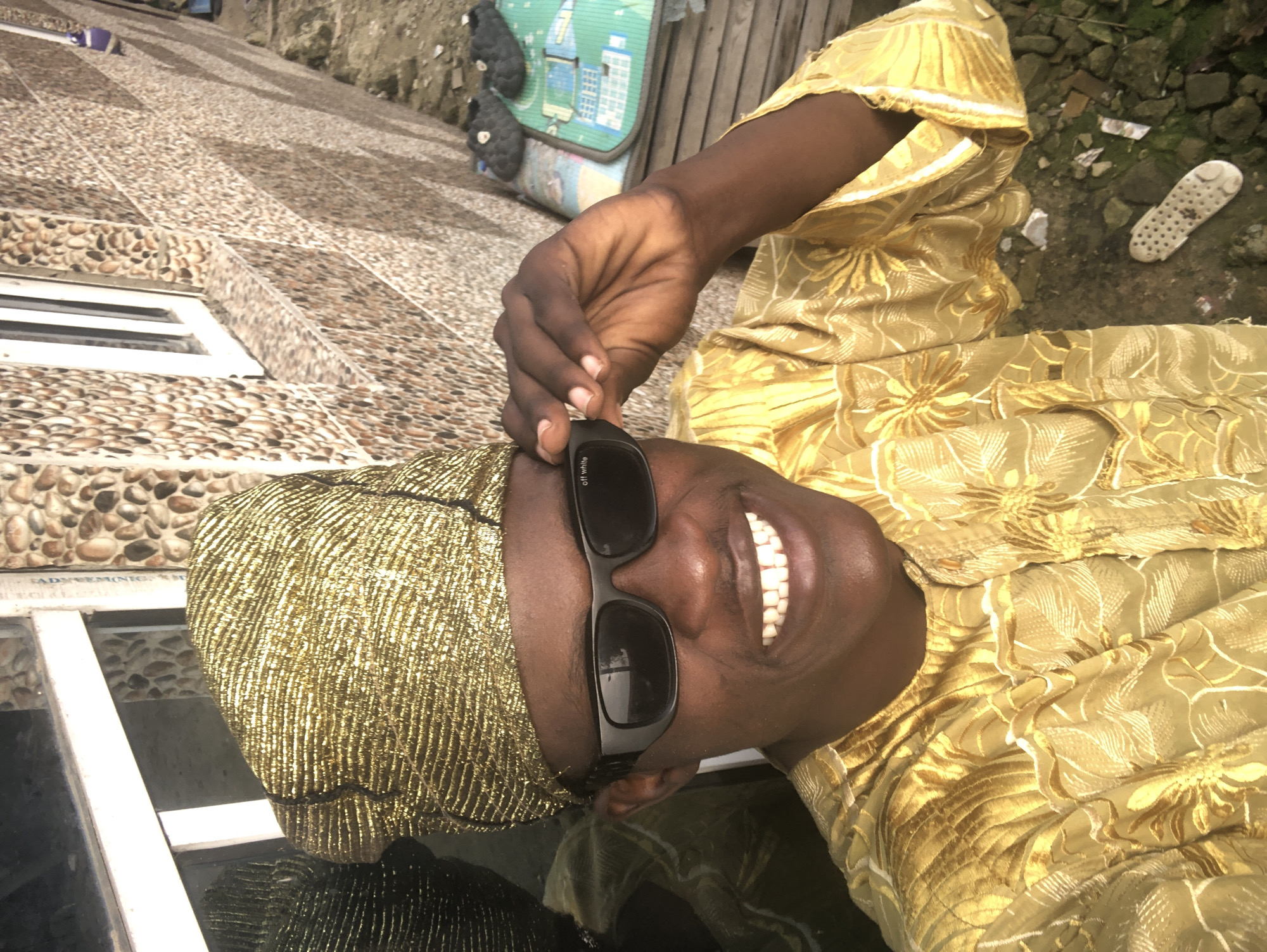Gold traditional attire and everyday street life in Ado, Nigeria