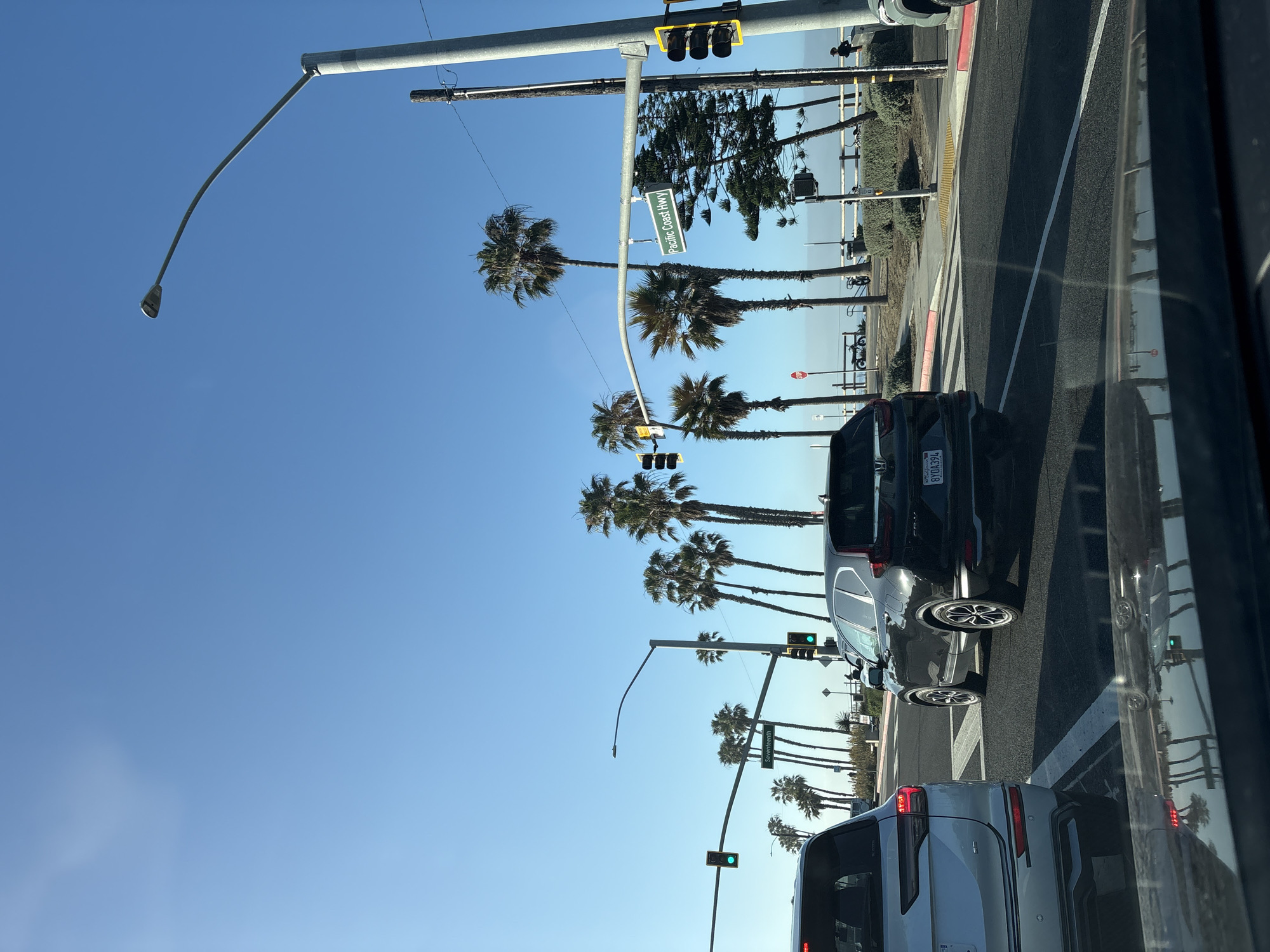 Driver documents casual PCH cruise with coffee in Huntington Beach