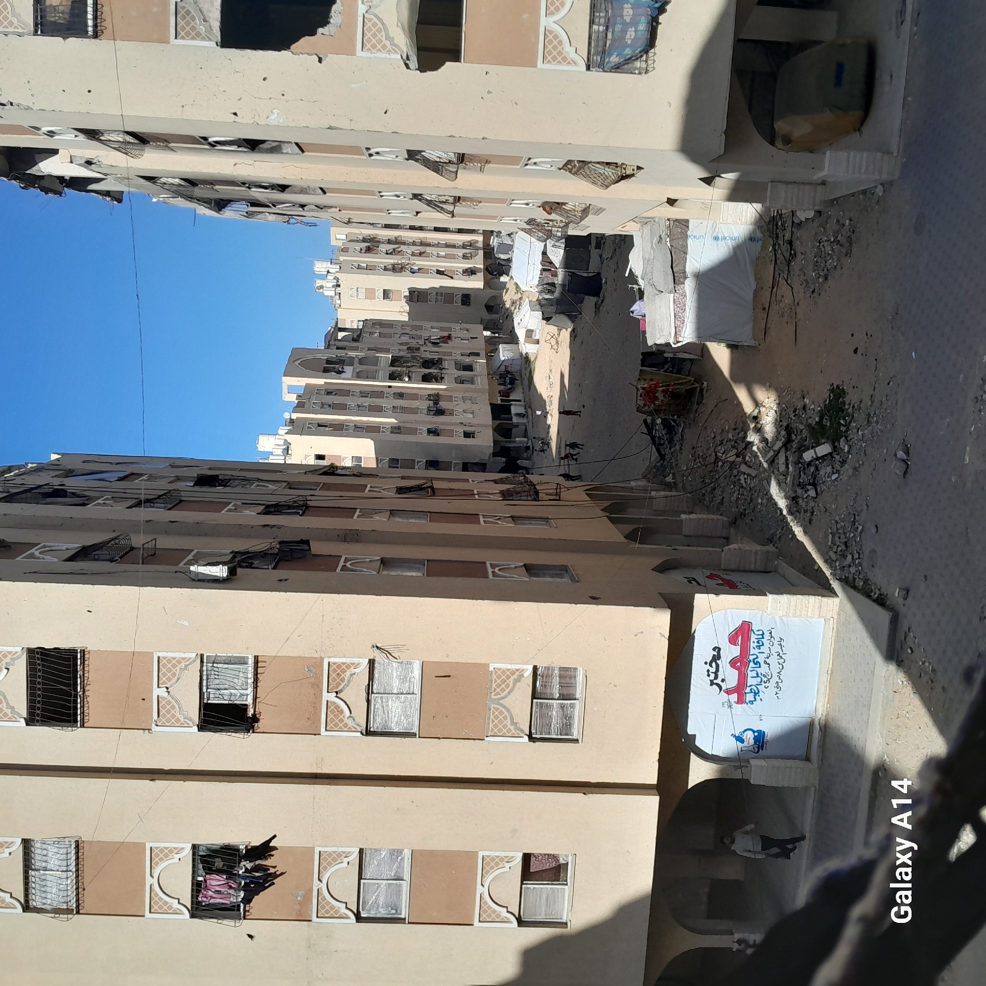 Damaged urban infrastructure observed through broken barrier