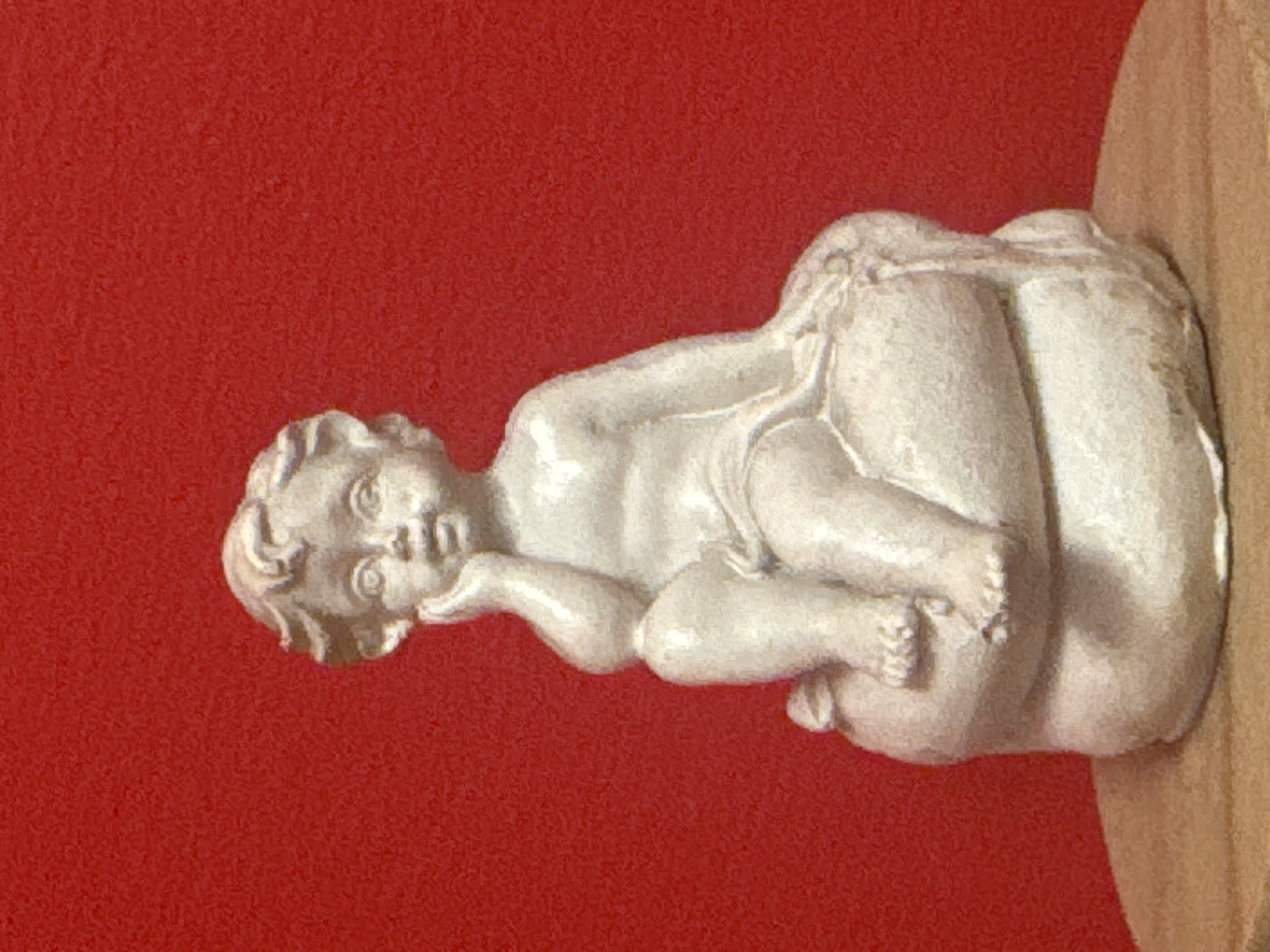 Decorative figurines and colorful puzzles displayed against red in Almaty