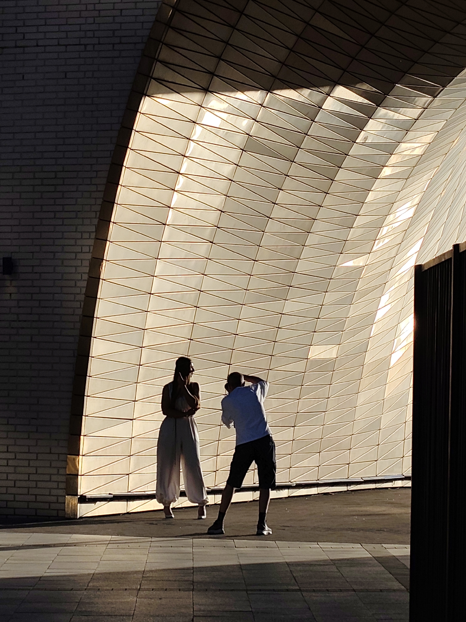 Two people silhouetted against lit Moscow architecture evening scene