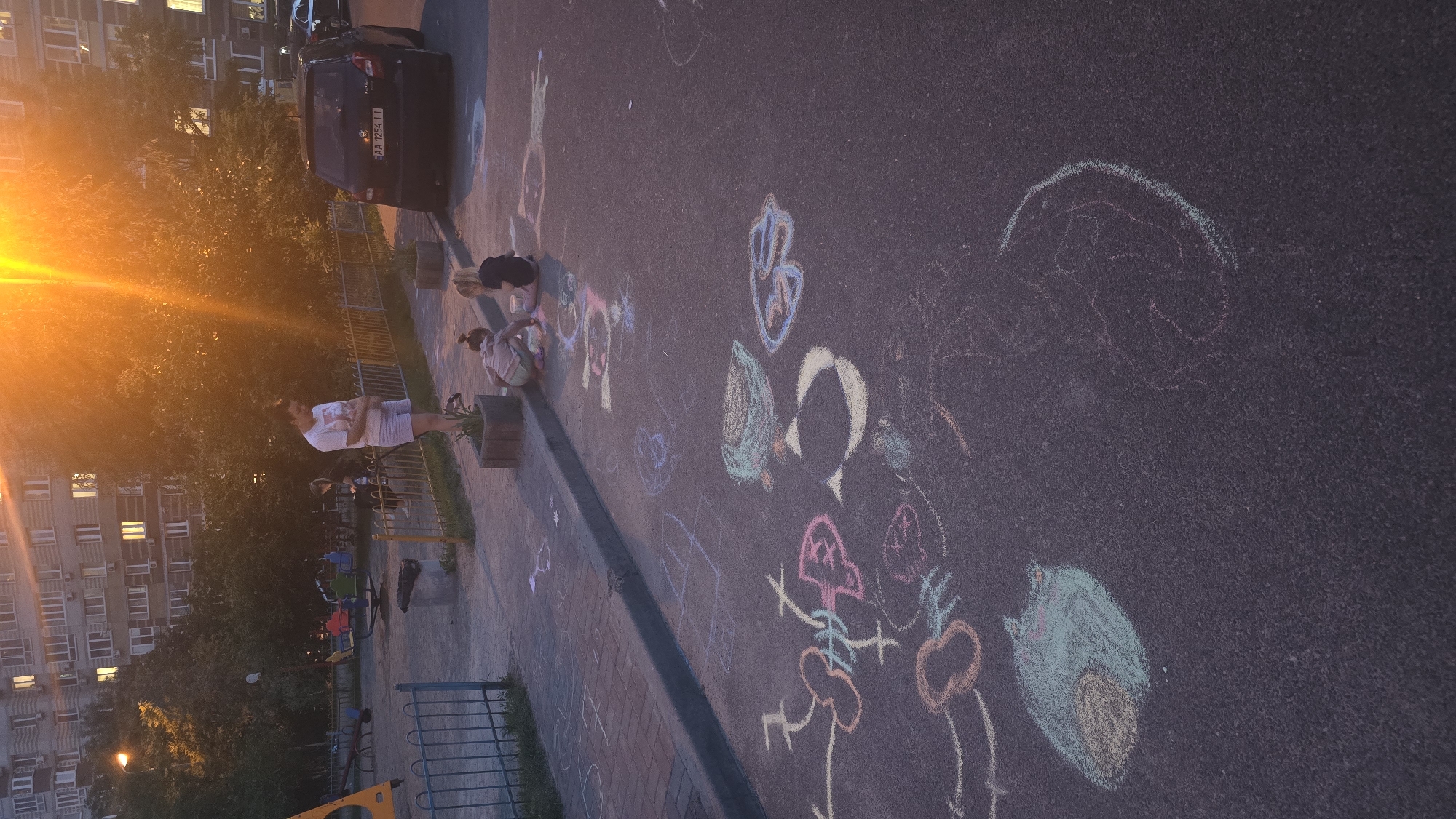 Evening chalk art session in Kyiv residential courtyard