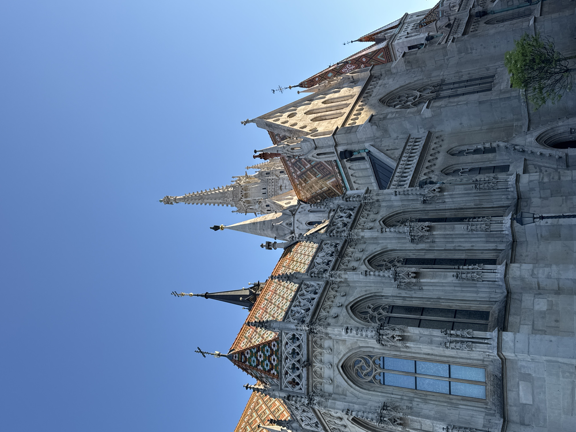Tourist documents Budapest's Castle Hill landmarks during afternoon visit