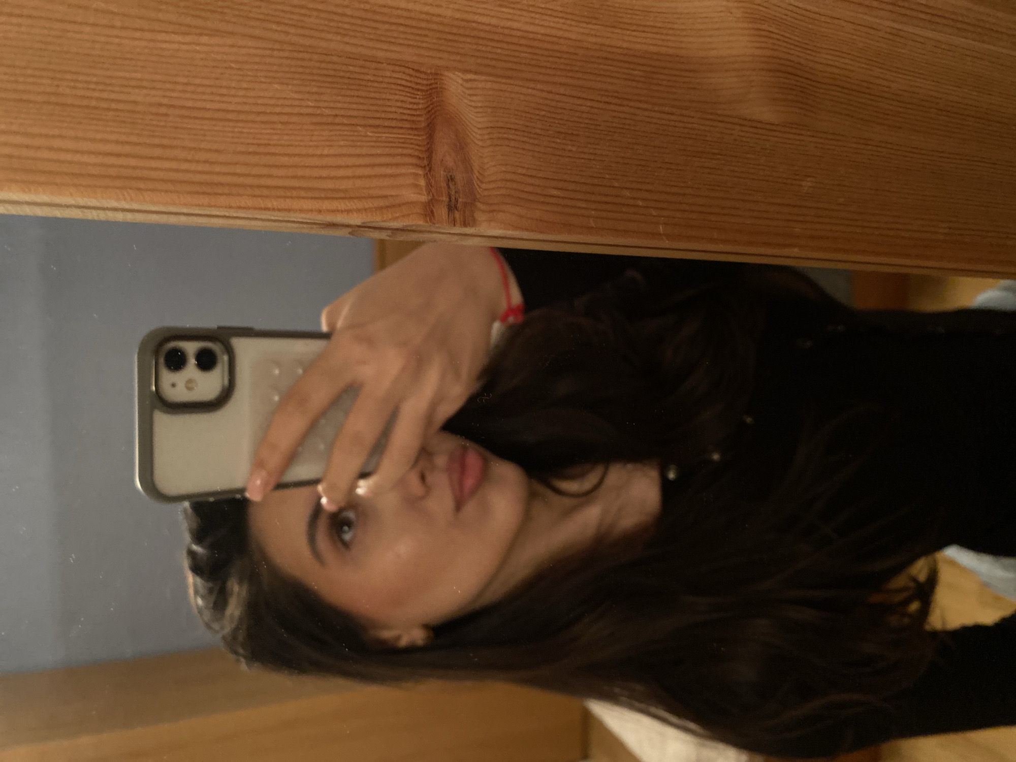 Woman takes mirror selfie in Björklinge, Sweden