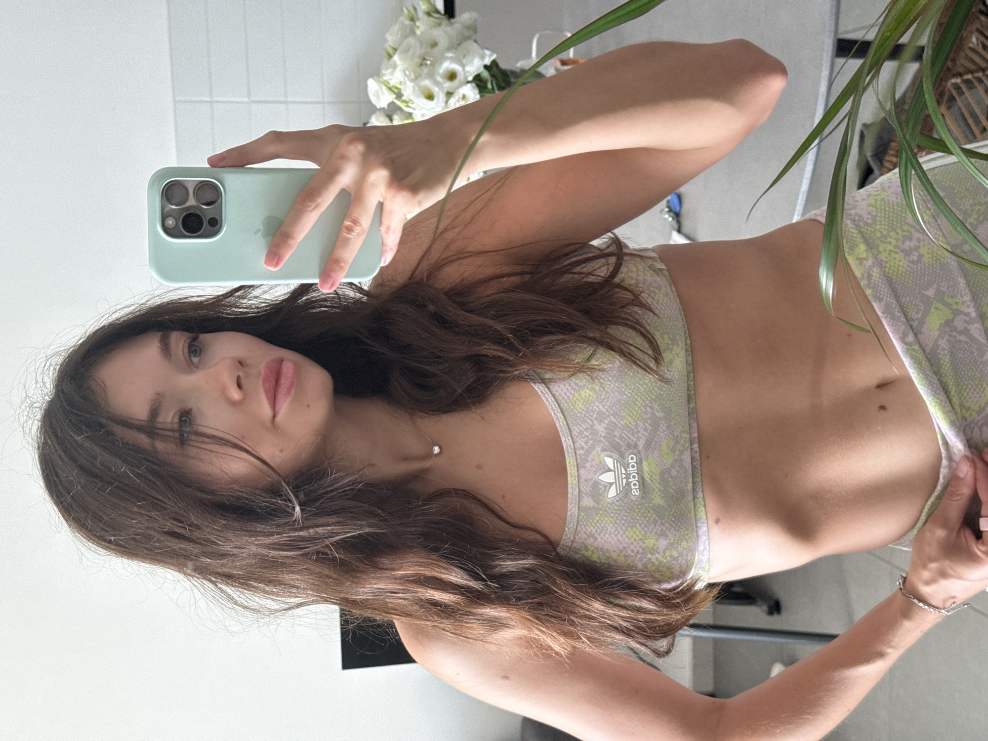 Woman takes early morning mirror selfies in Tel Aviv apartment
