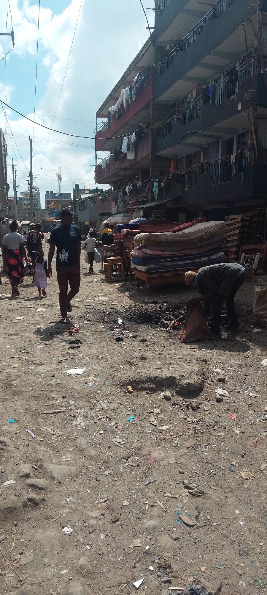 Man searches debris on littered Nairobi street