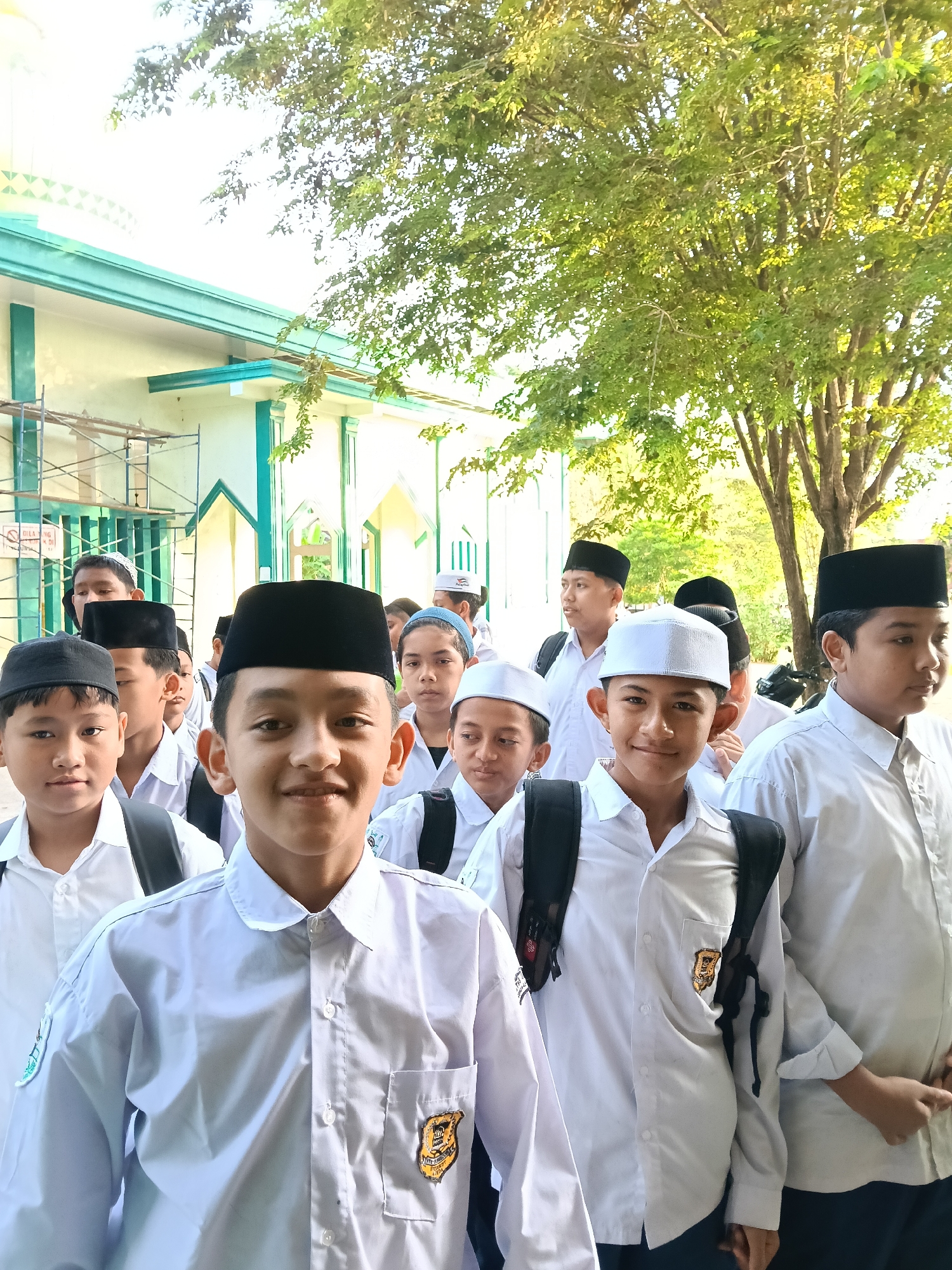 Students gather near mosque building in Lhokseumawe, Indonesia