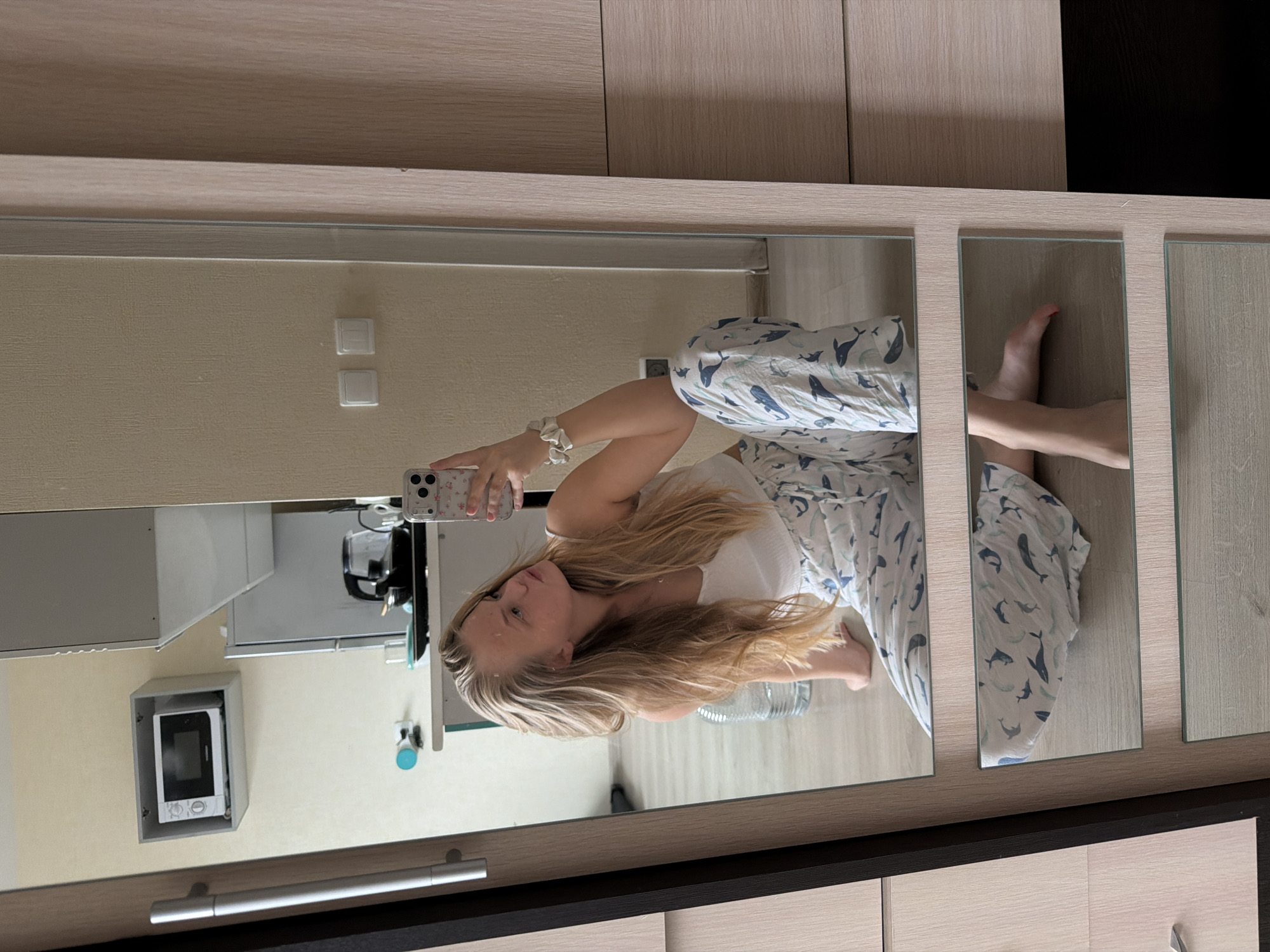 Woman takes late-night mirror selfies in whale pajamas