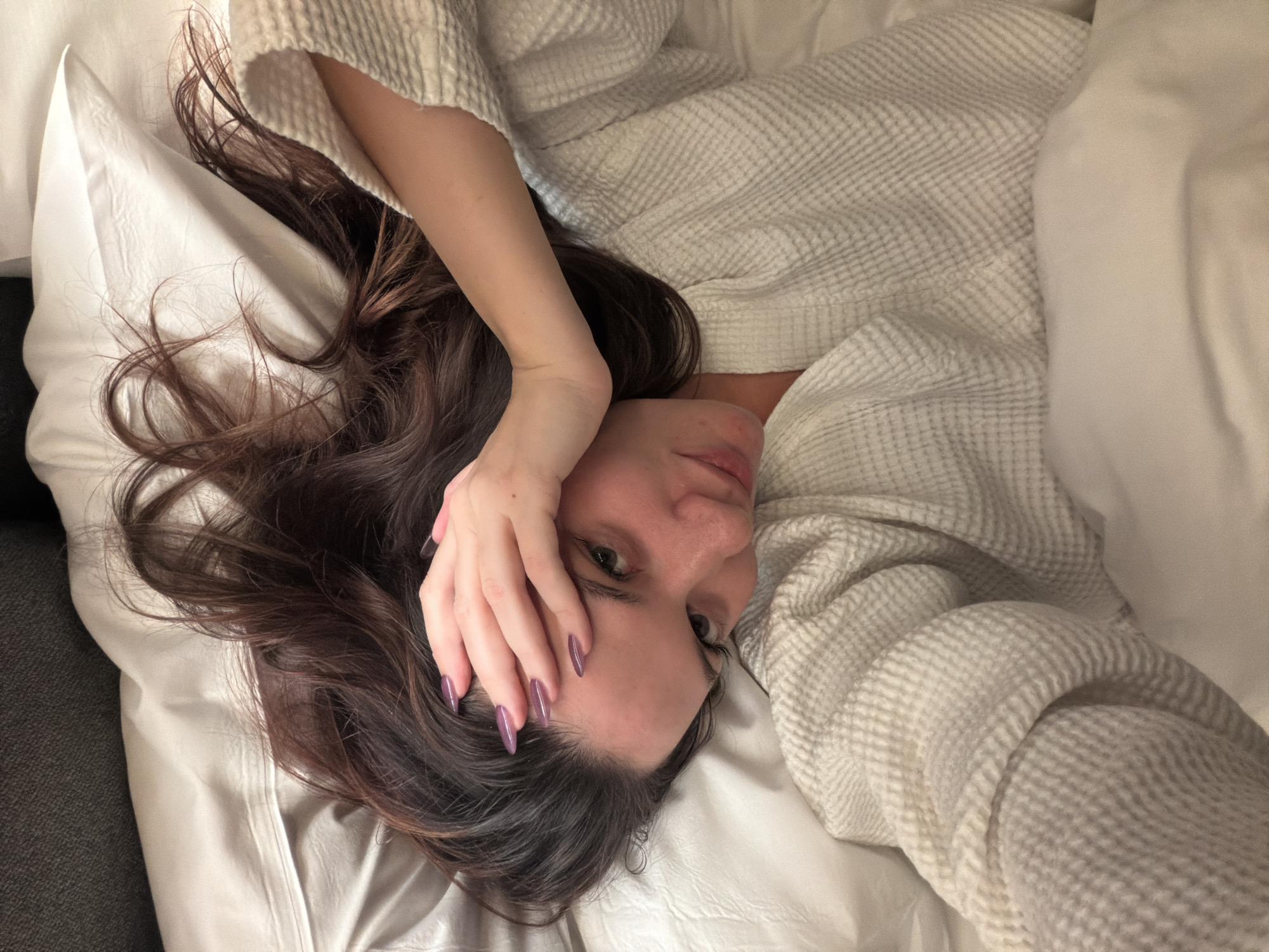 Woman photographed on bed in Athens residence
