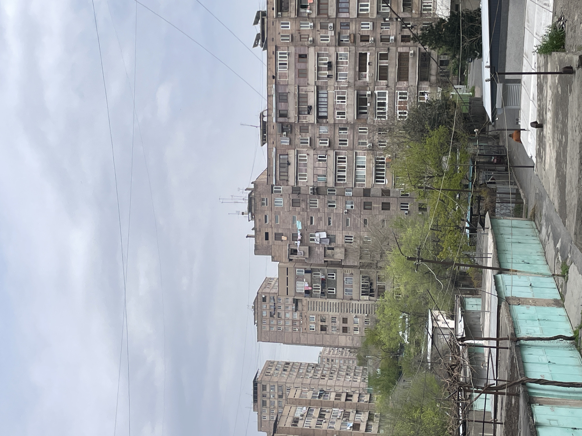 Morning documentation of Soviet-era buildings under overcast Yerevan skies