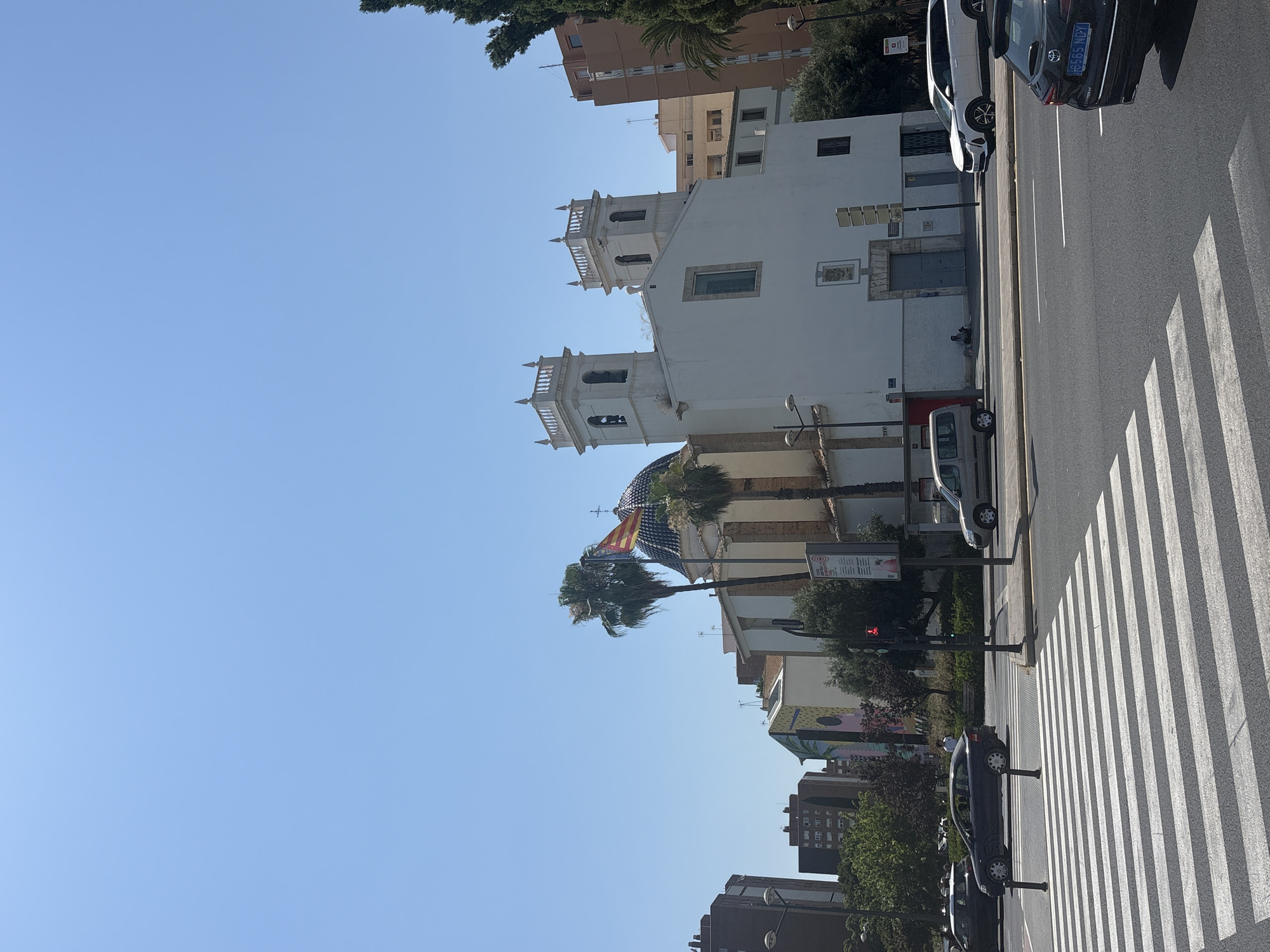 Midday street traffic near a pedestrian crossing in Valencia