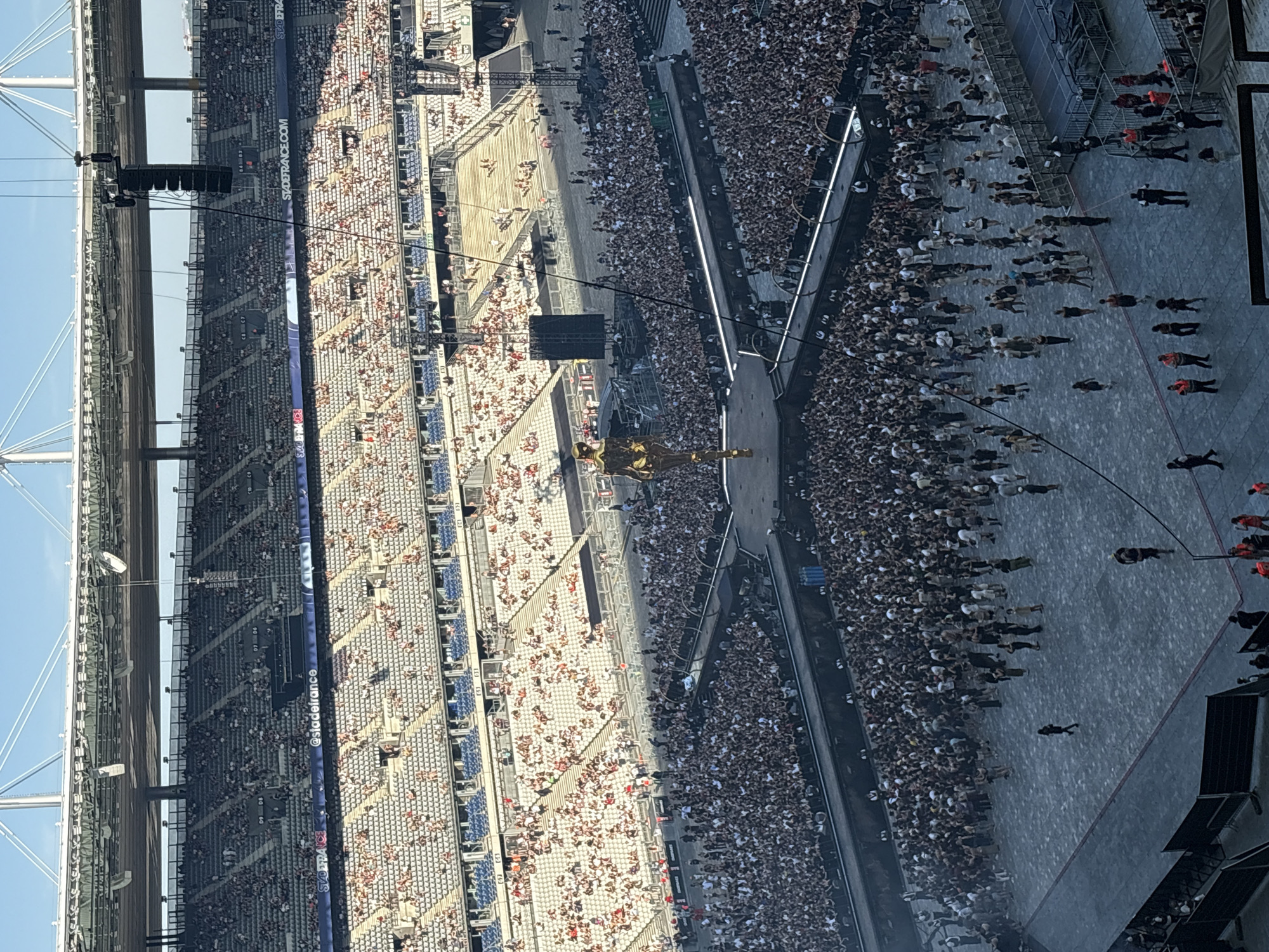 Massive stadium concert underway in Saint-Denis with golden centerpiece