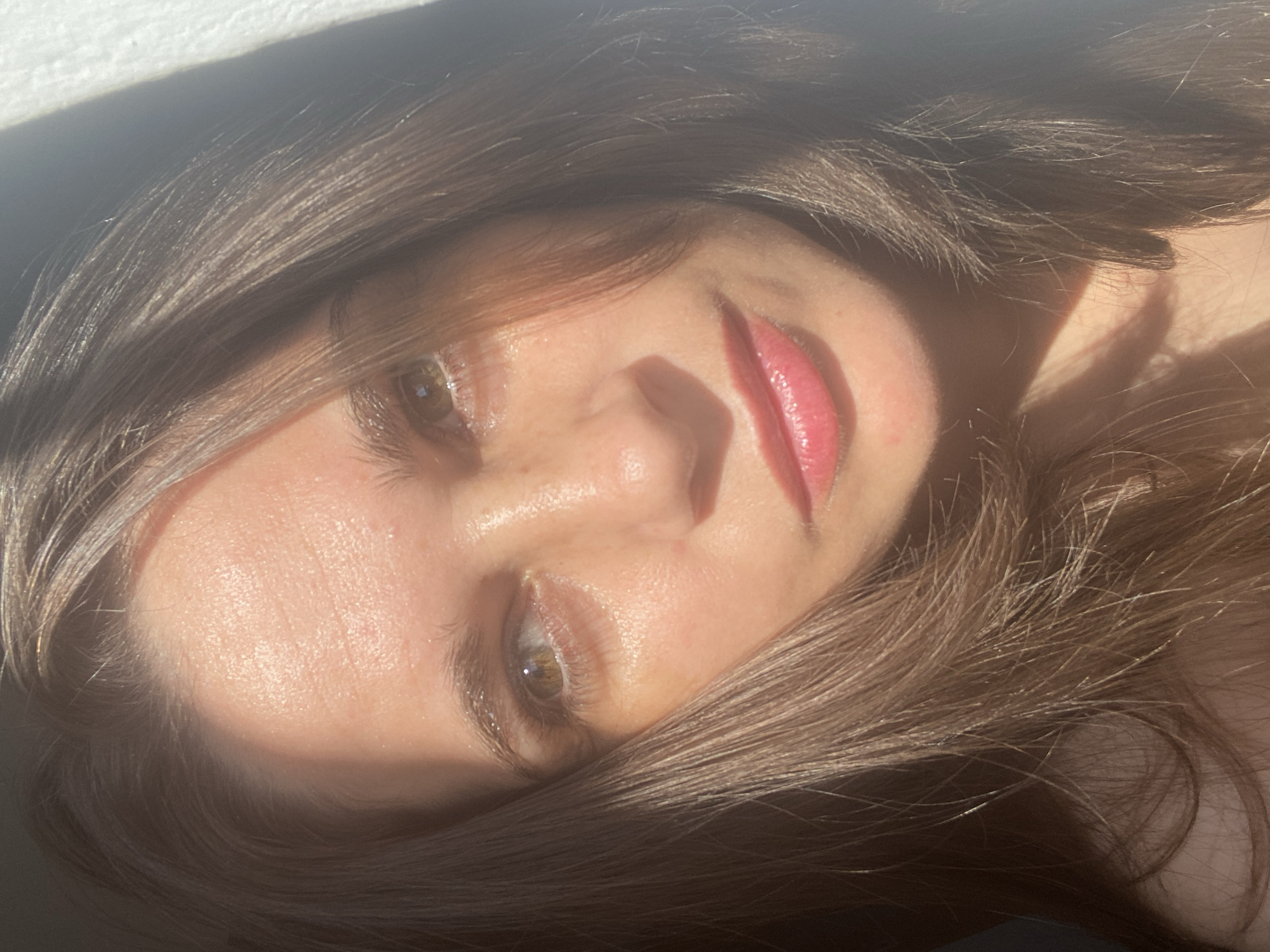Sunlit close-up portrait with natural shadow across the face