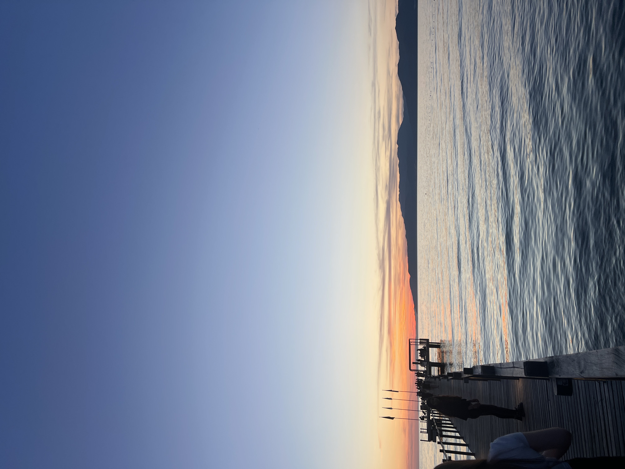 Sunset gathering documented on wooden pier in Selçuk, Turkey