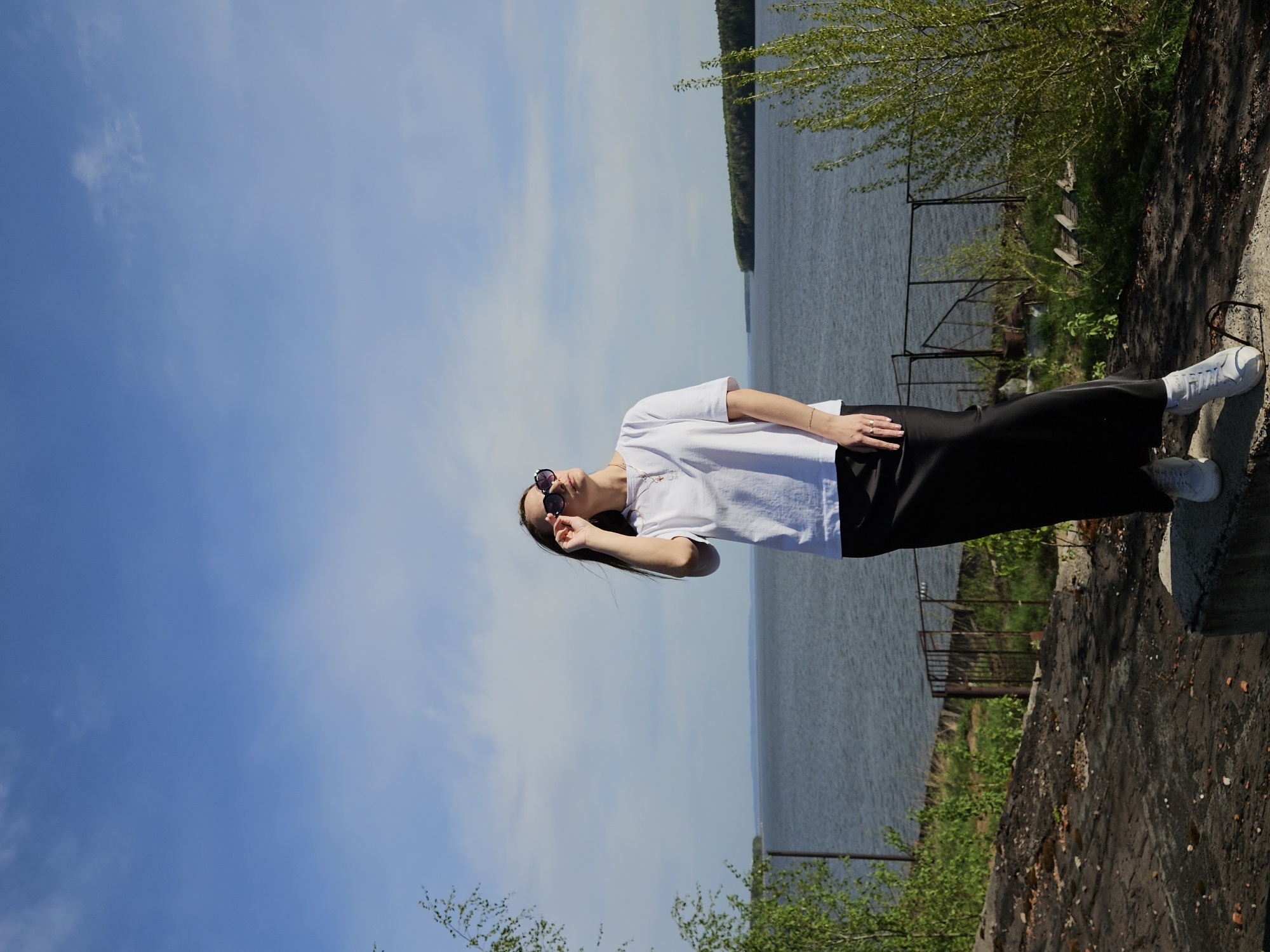 Woman poses for photos near water in Chaikovsky, Russia