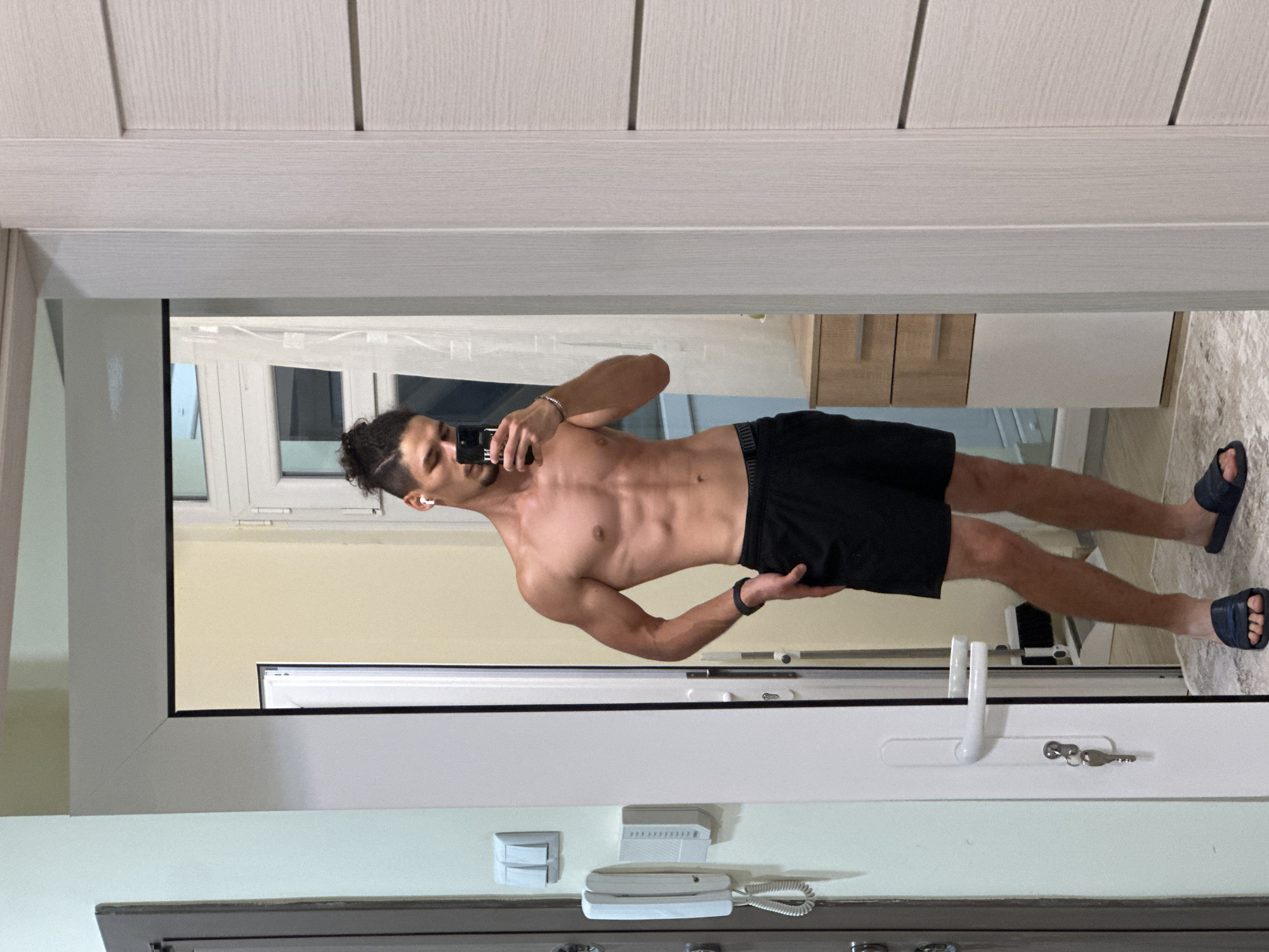 Mirror selfie session in a Varna apartment hallway