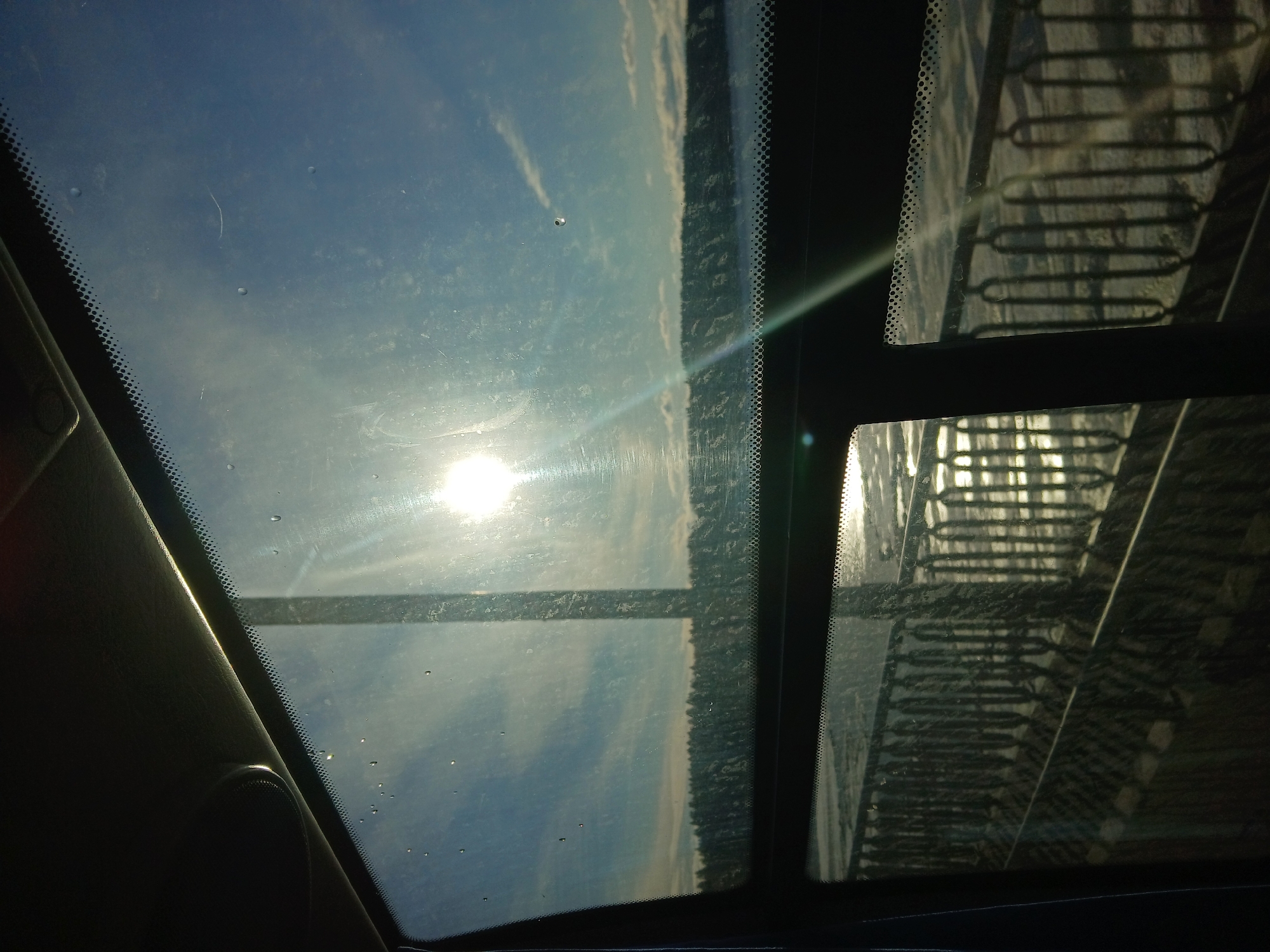 Driver captures sunny sky view through vehicle windows in Usolye