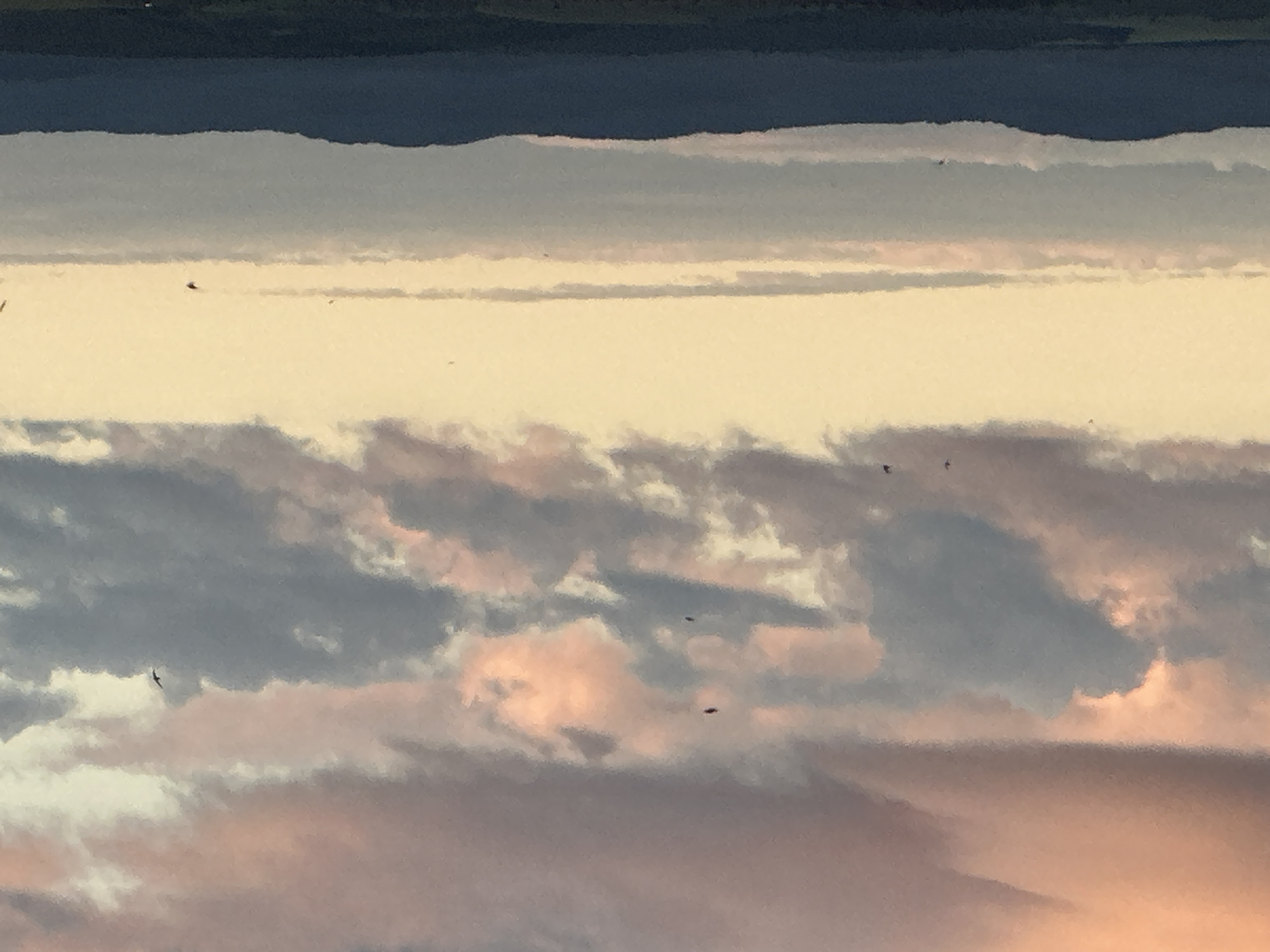 Aerial landscape with layered clouds captured during sunset hours