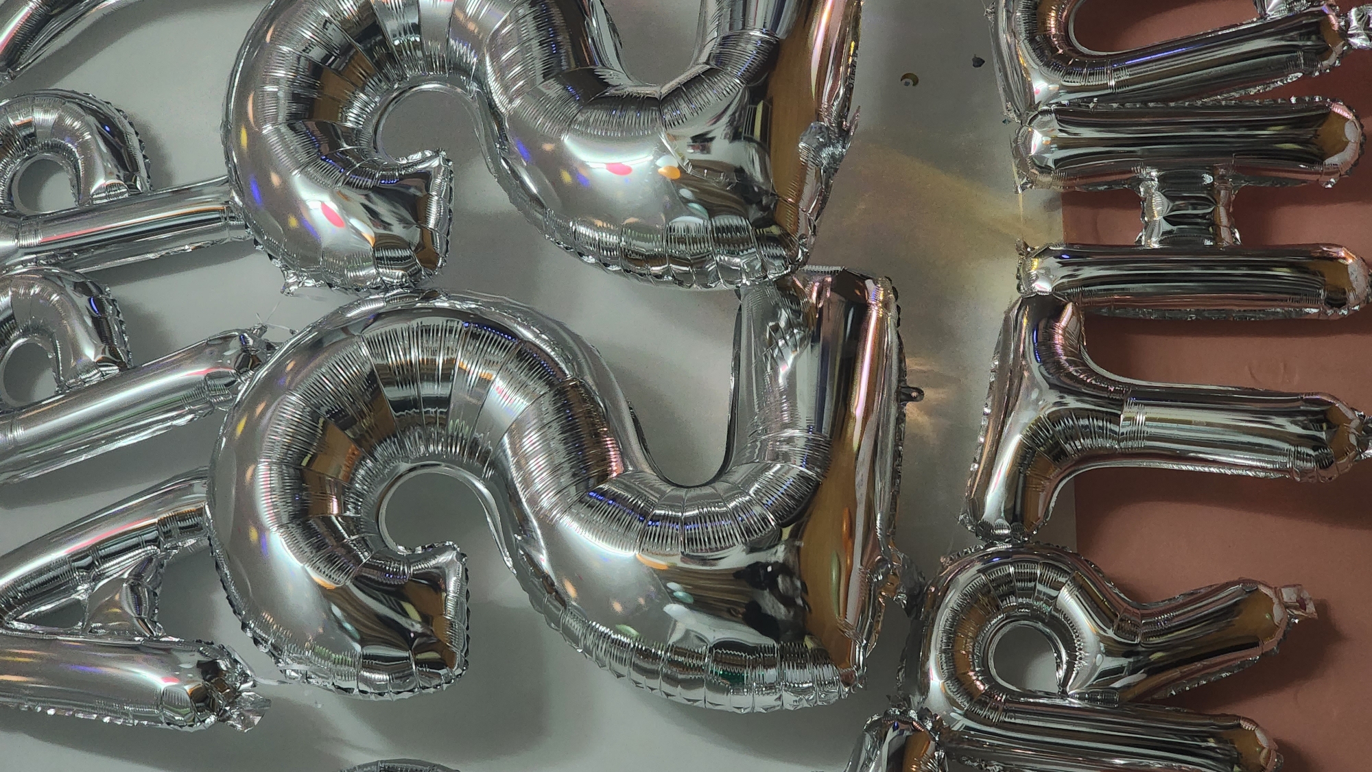 Silver "2024" balloons displayed on wall in Zhongtun