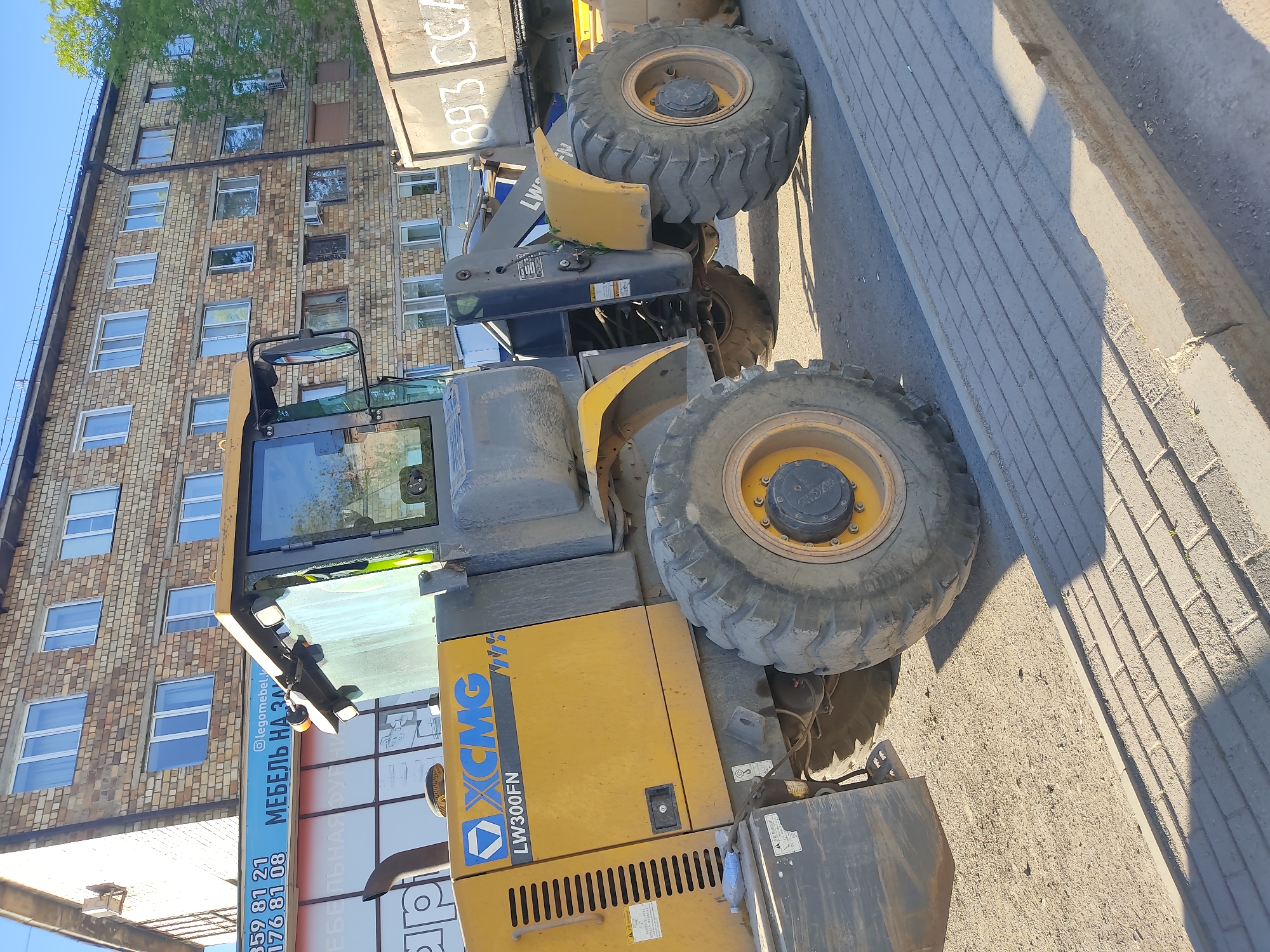 Construction Equipment Parked on Street Near Building