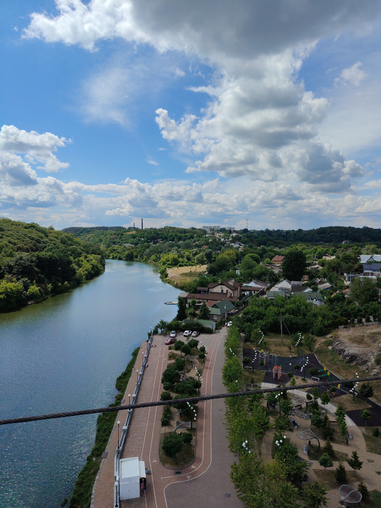 Aerial views of a calm riverside town with parks
