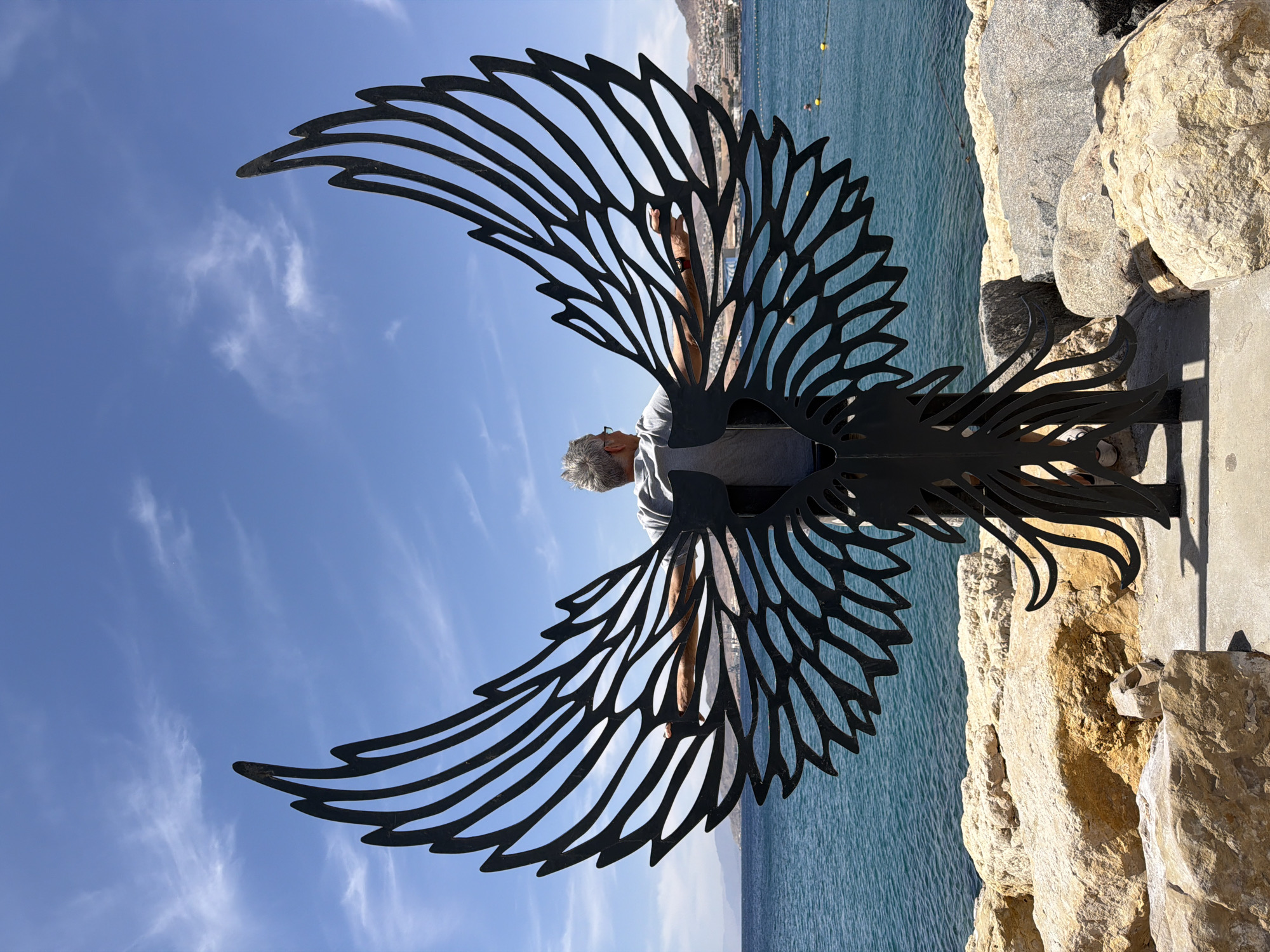 Man views wing sculpture at Eilat coastal area