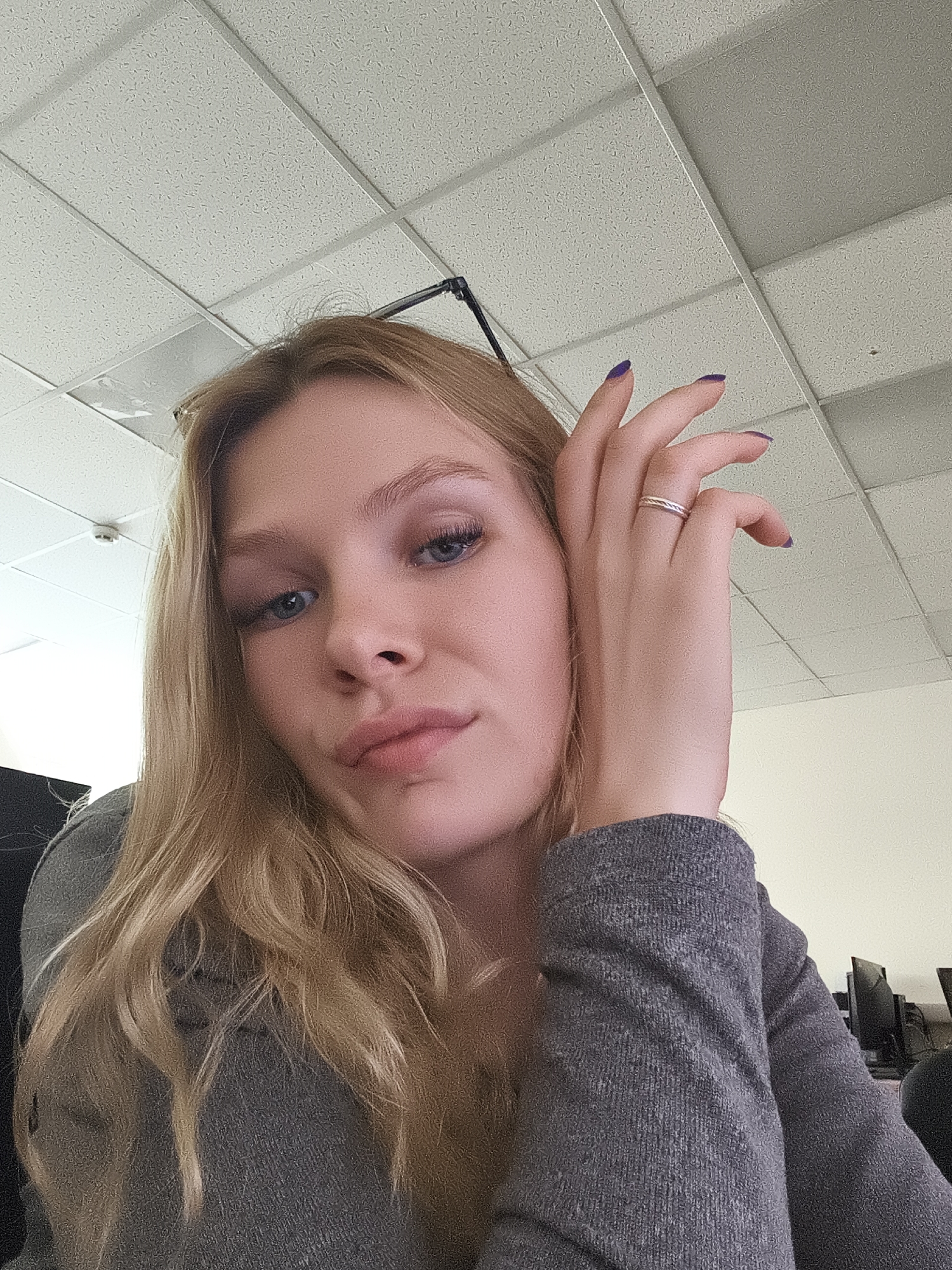 Woman poses with bread rings in office selfie session