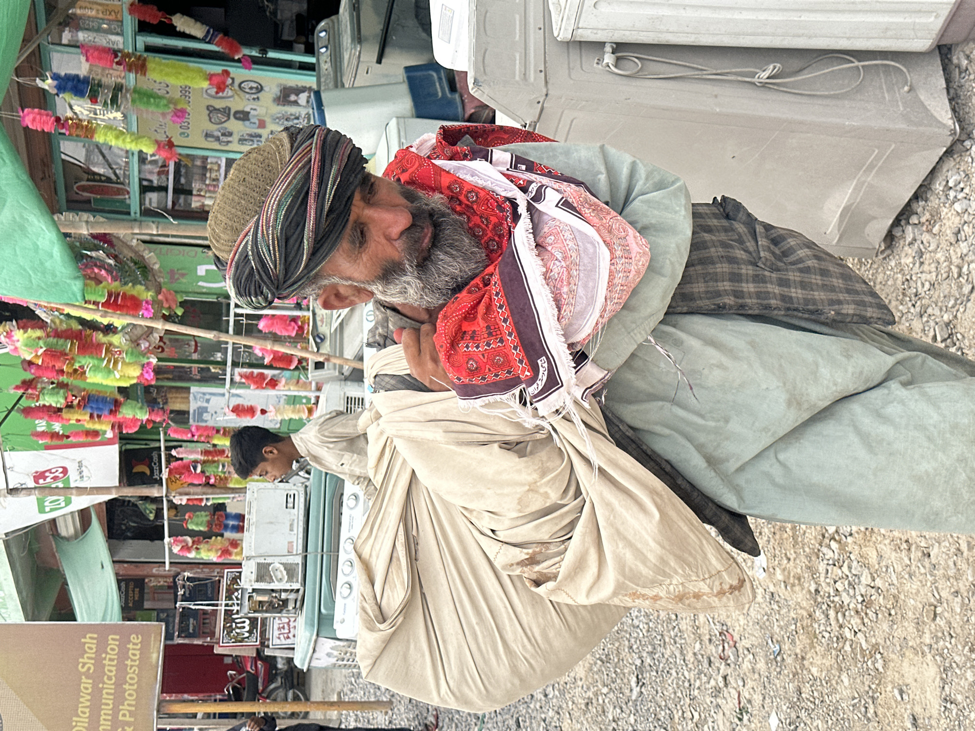 Carrying a large cloth bundle through Quetta streets