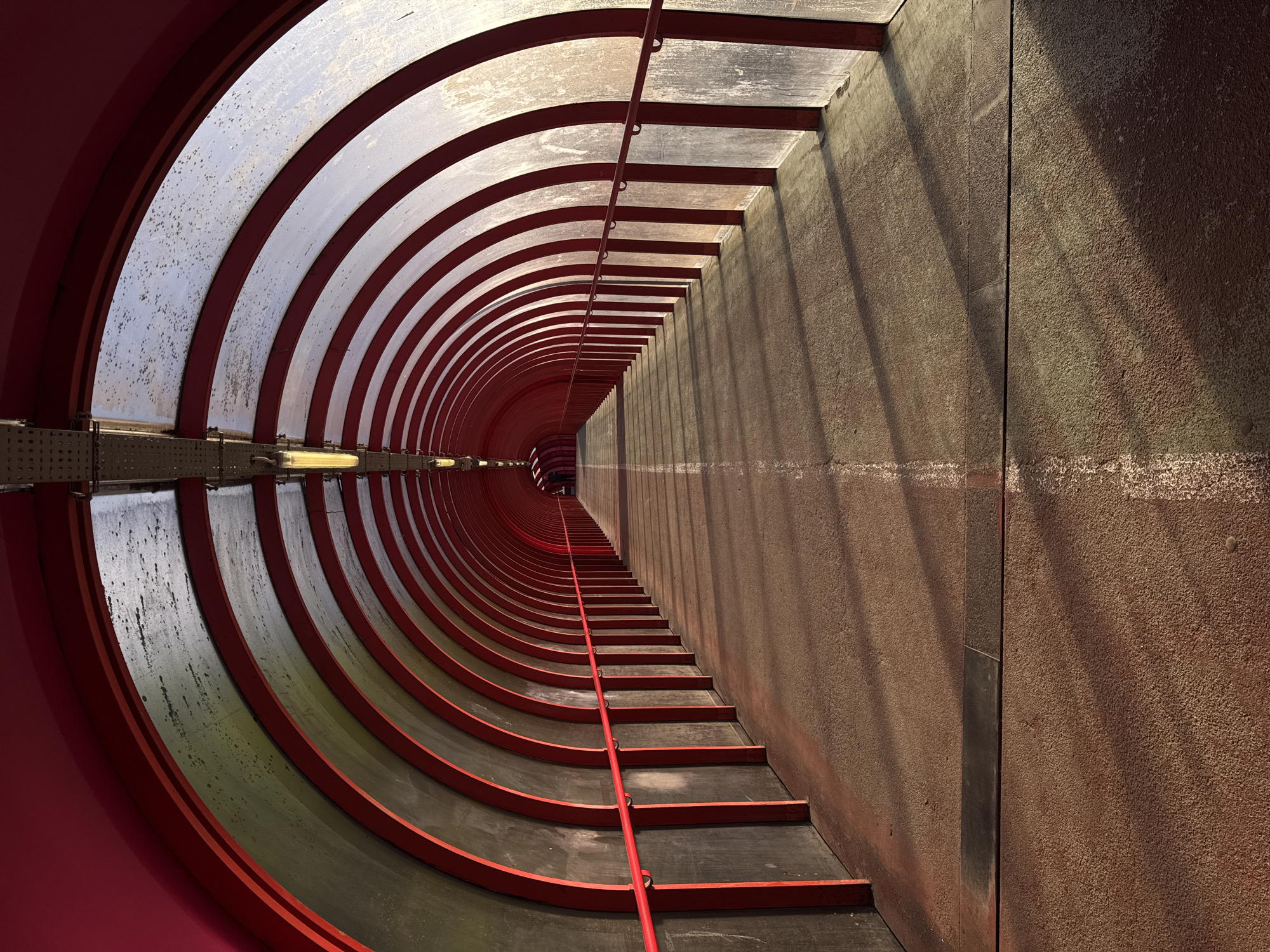 Red-framed pedestrian tunnel documented in Glasgow morning hours