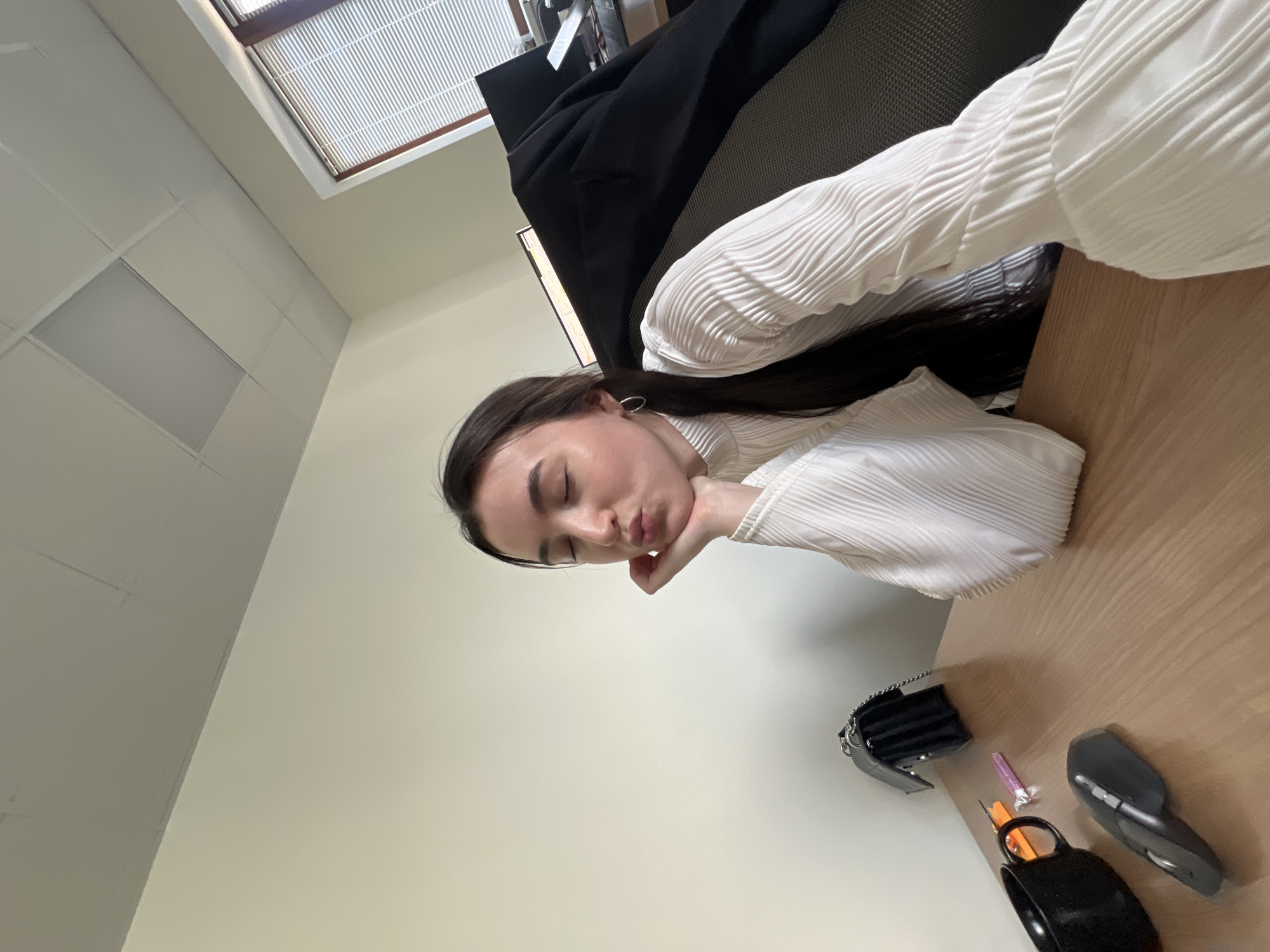 Woman Takes Rest Break at Office Desk in Kazan