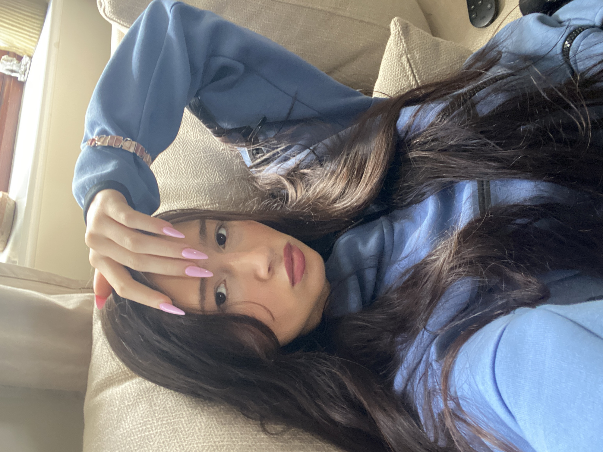 Woman rests on sofa in Reigate area