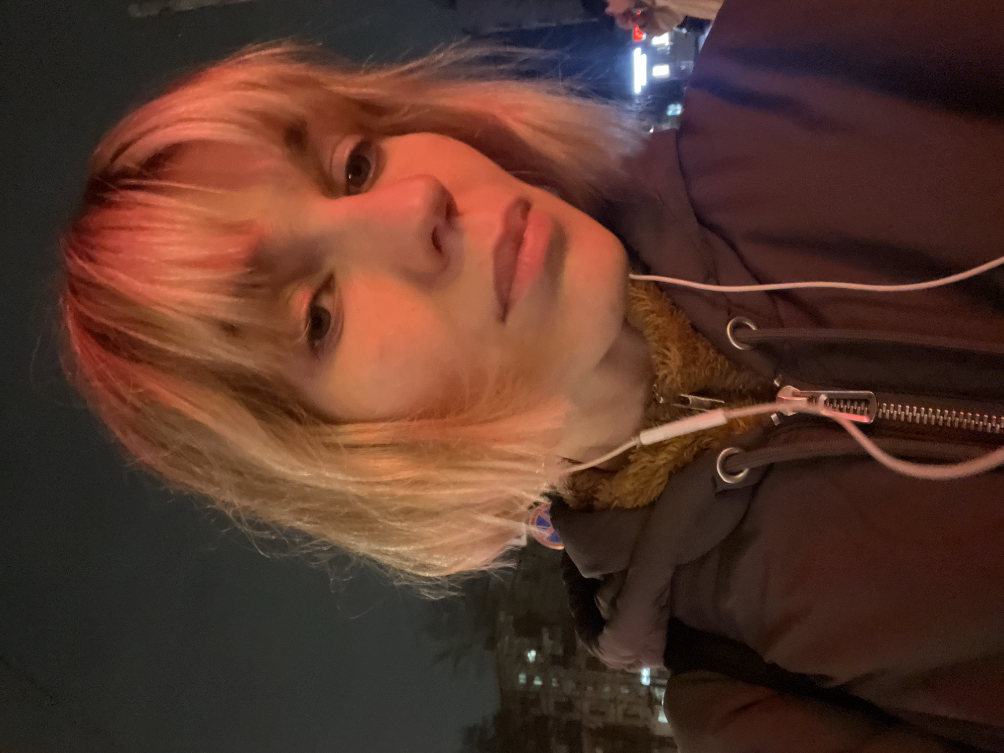 Person in fur jacket photographed on Moscow street at night
